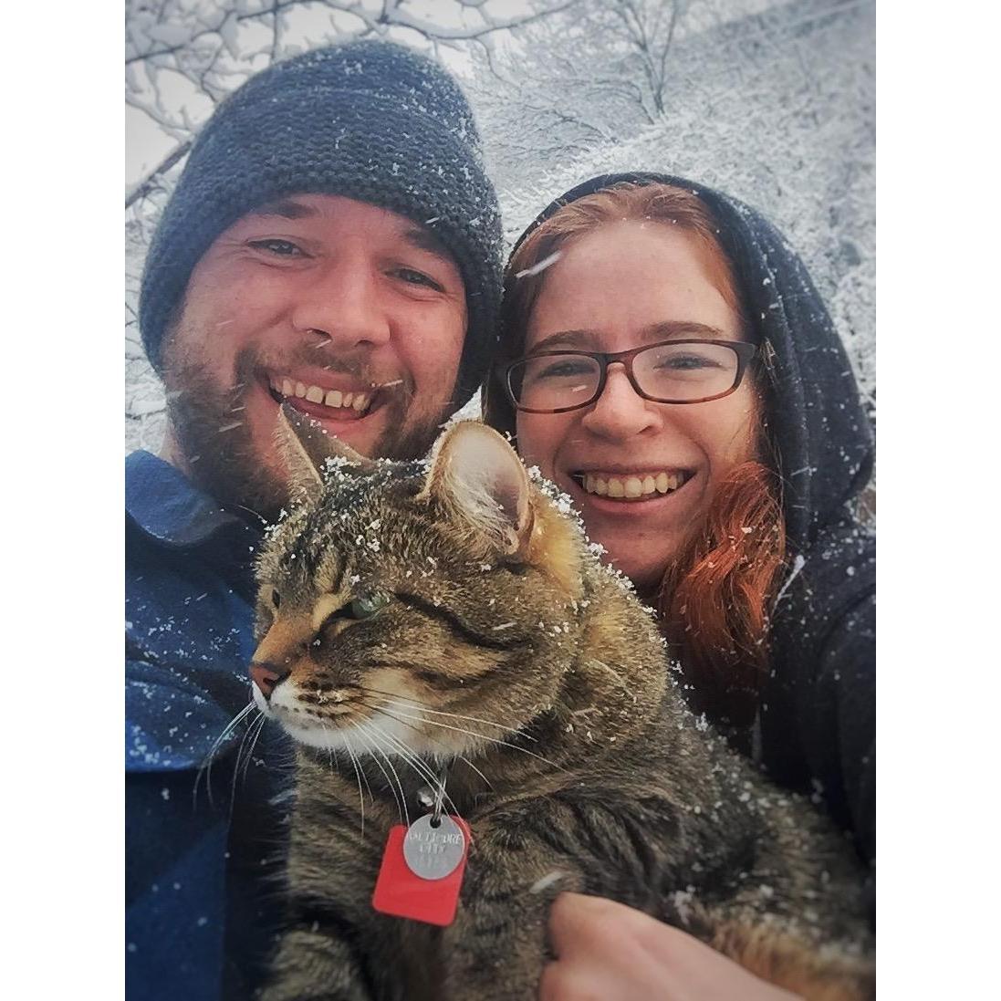 Hannah and Nate on a snow day in 2018 with their cat, J.J.