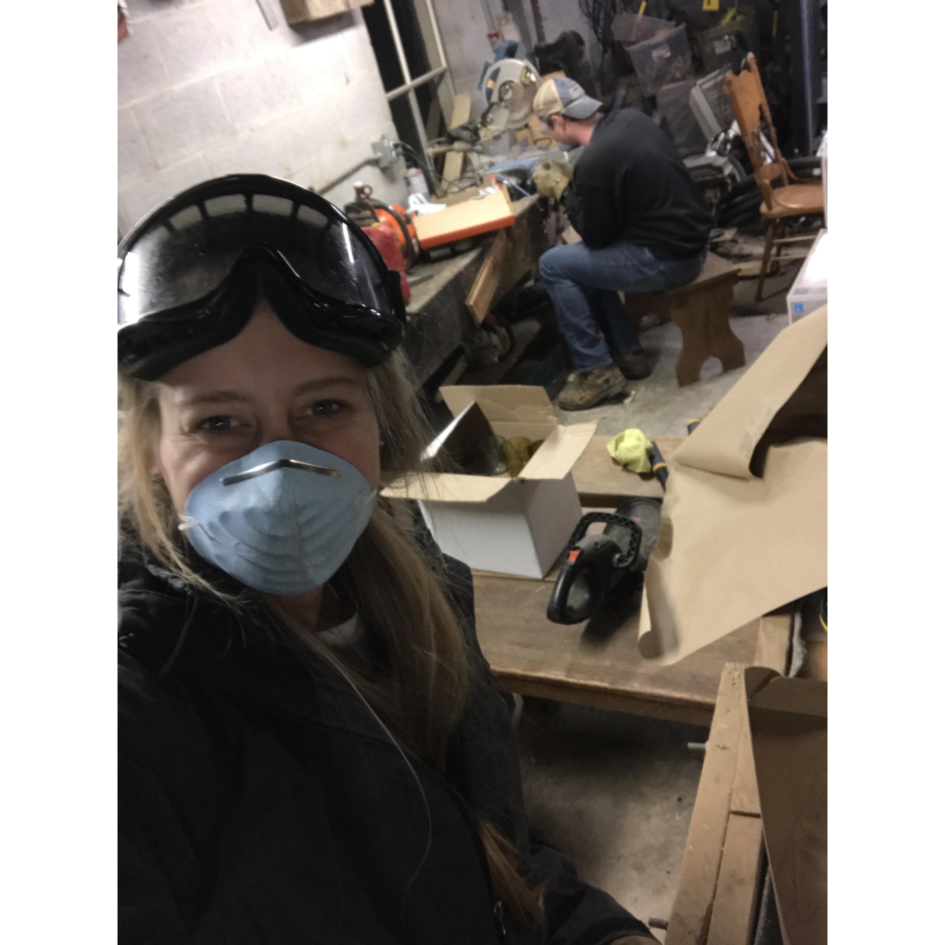 Sanding down the newly-cut glass.