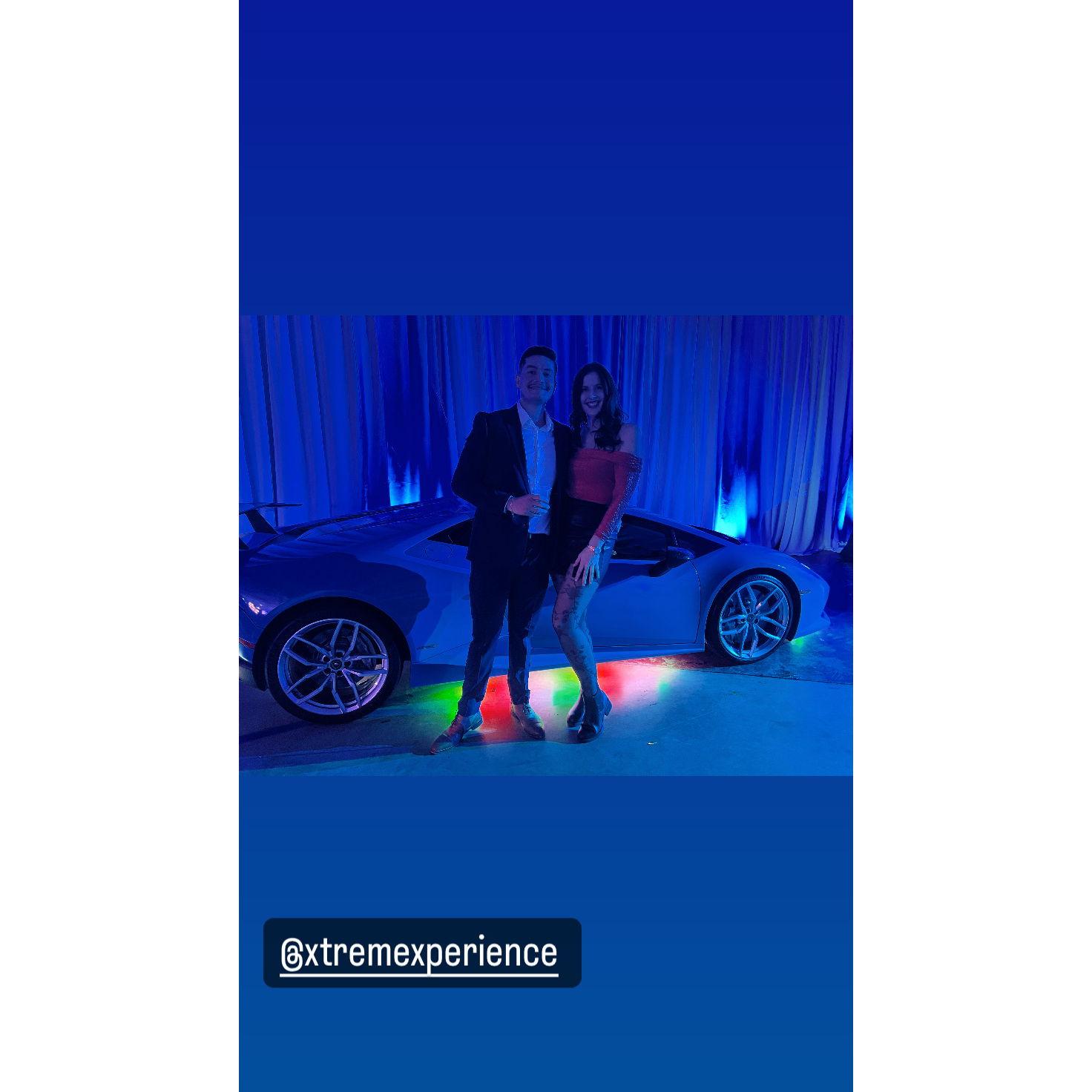 Perks of Luis' work include posing with super cars