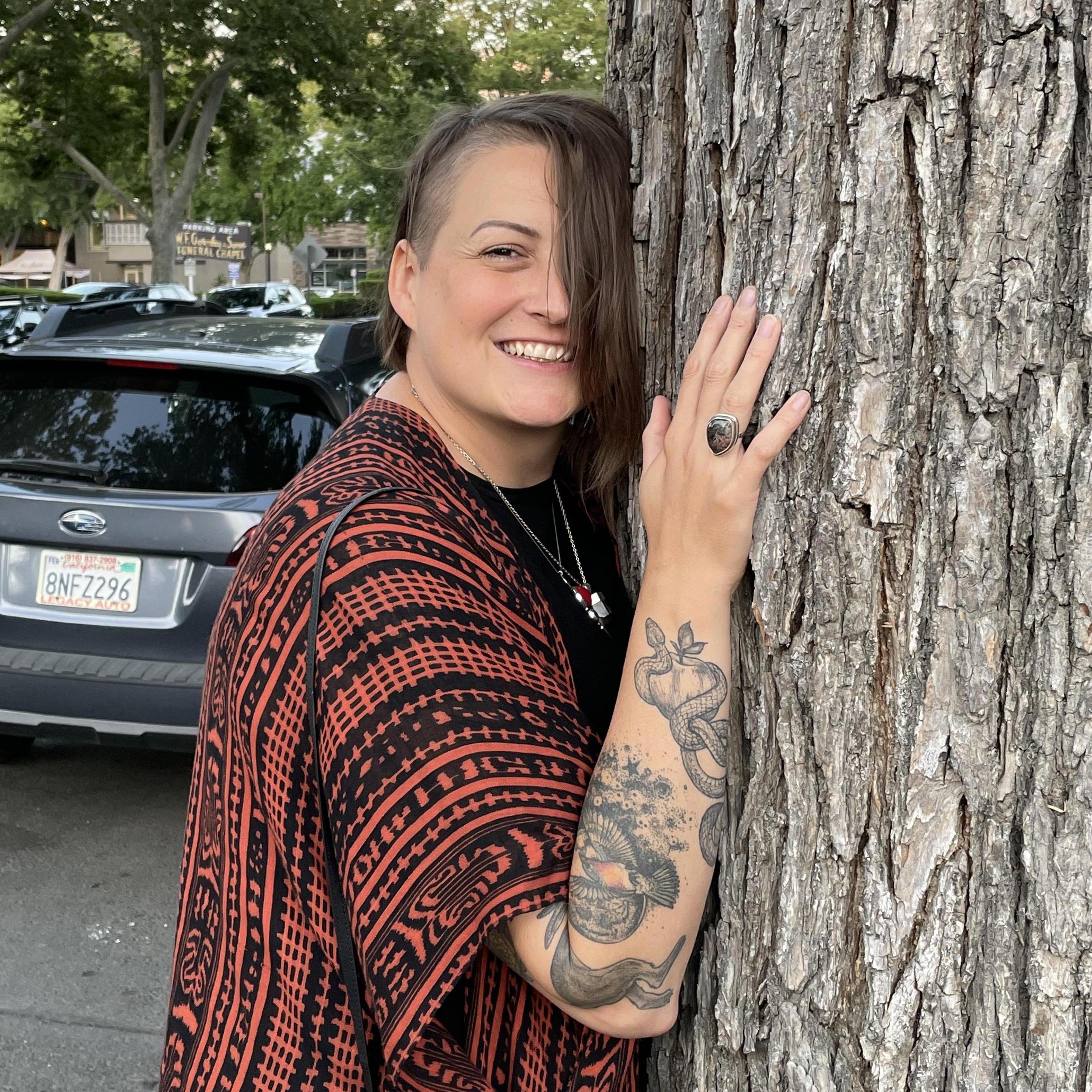 A photo James took of Despi hugging a tree in Sacramento after a really amazing dinner. This was the day Despi knew James was going to propose.