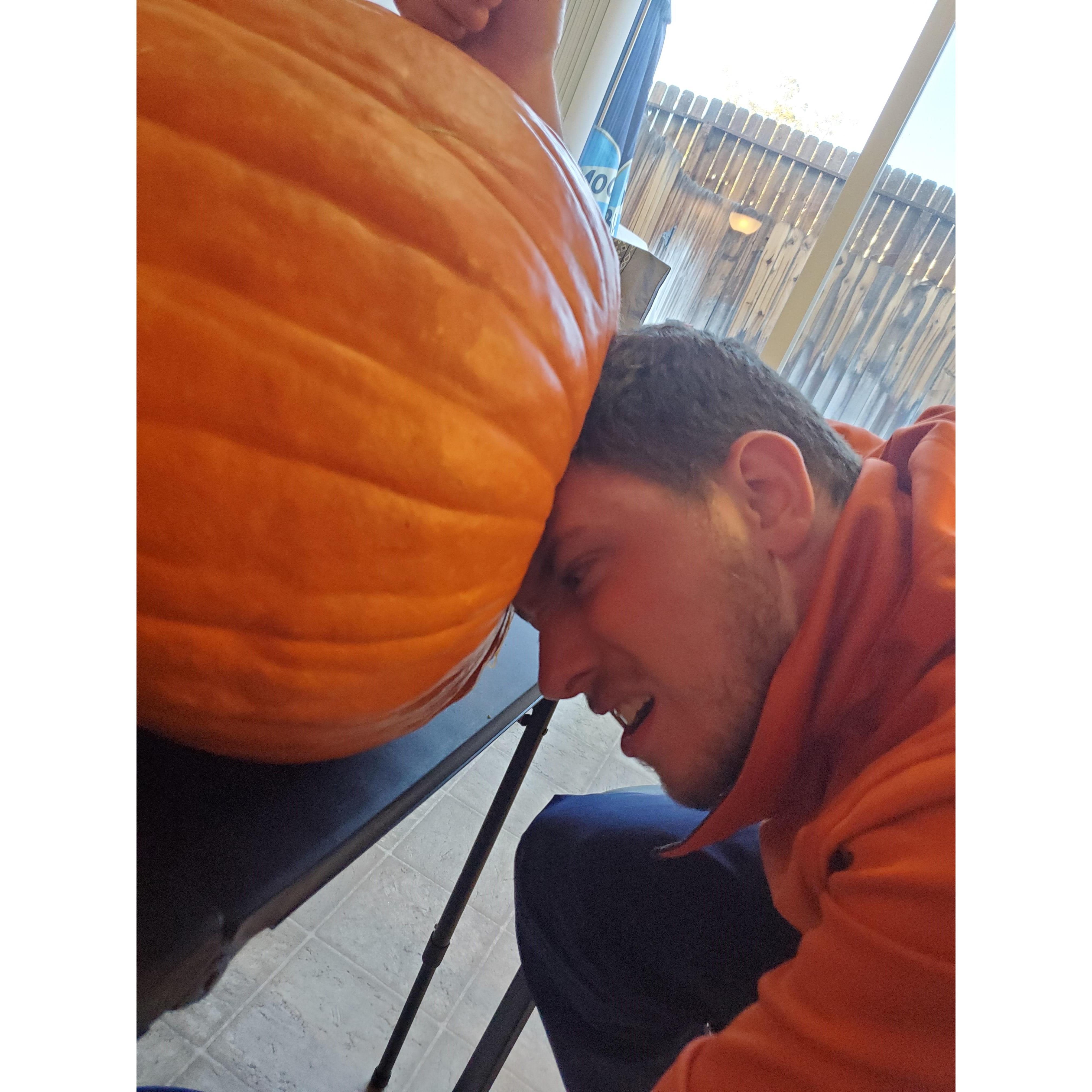 Carving pumpkins together. he tried to fit his head in his pumpkin