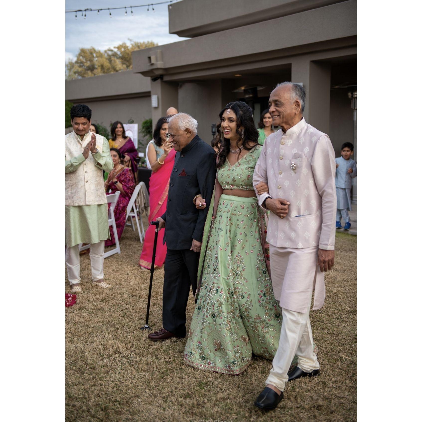 Both our Dada's walking Anika into our engagement puja