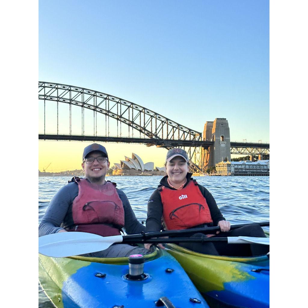 Jo and Hanah kayaking the Sydney Harbor with the Sydney Opera House in the background