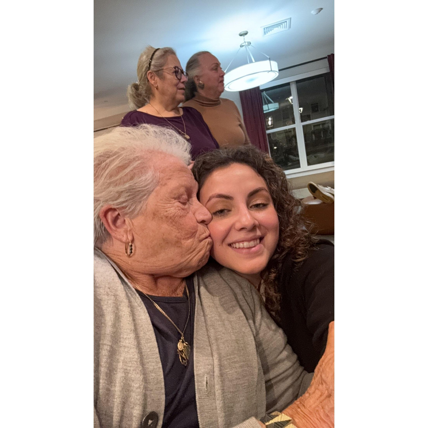 My cute Nonna and I at our engagement dinner. (Ft. the moms in the background)