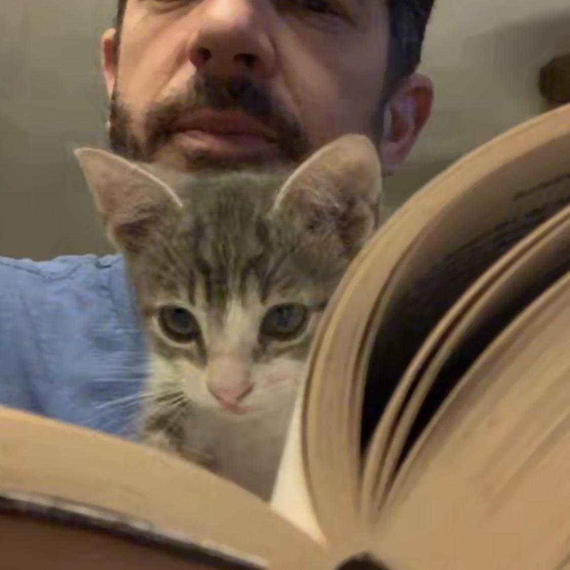Love is a man with a cat and a book