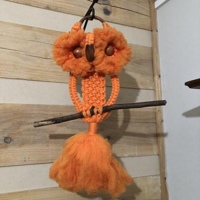 1970s orange macrame owl with wood bead eyes and beak
