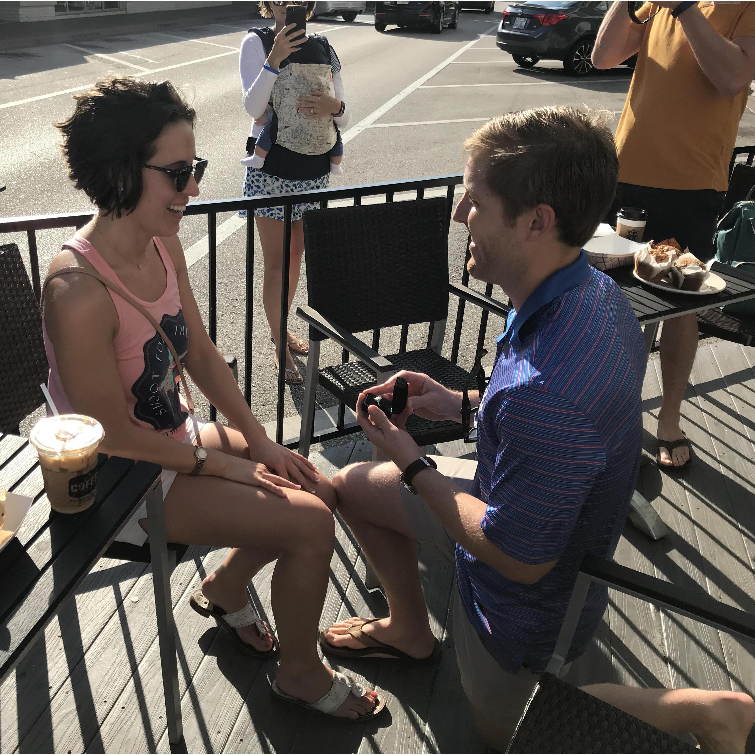 The proposal! Grant surprised Katie at the site of their first date with her parents and friends there to celebrate!