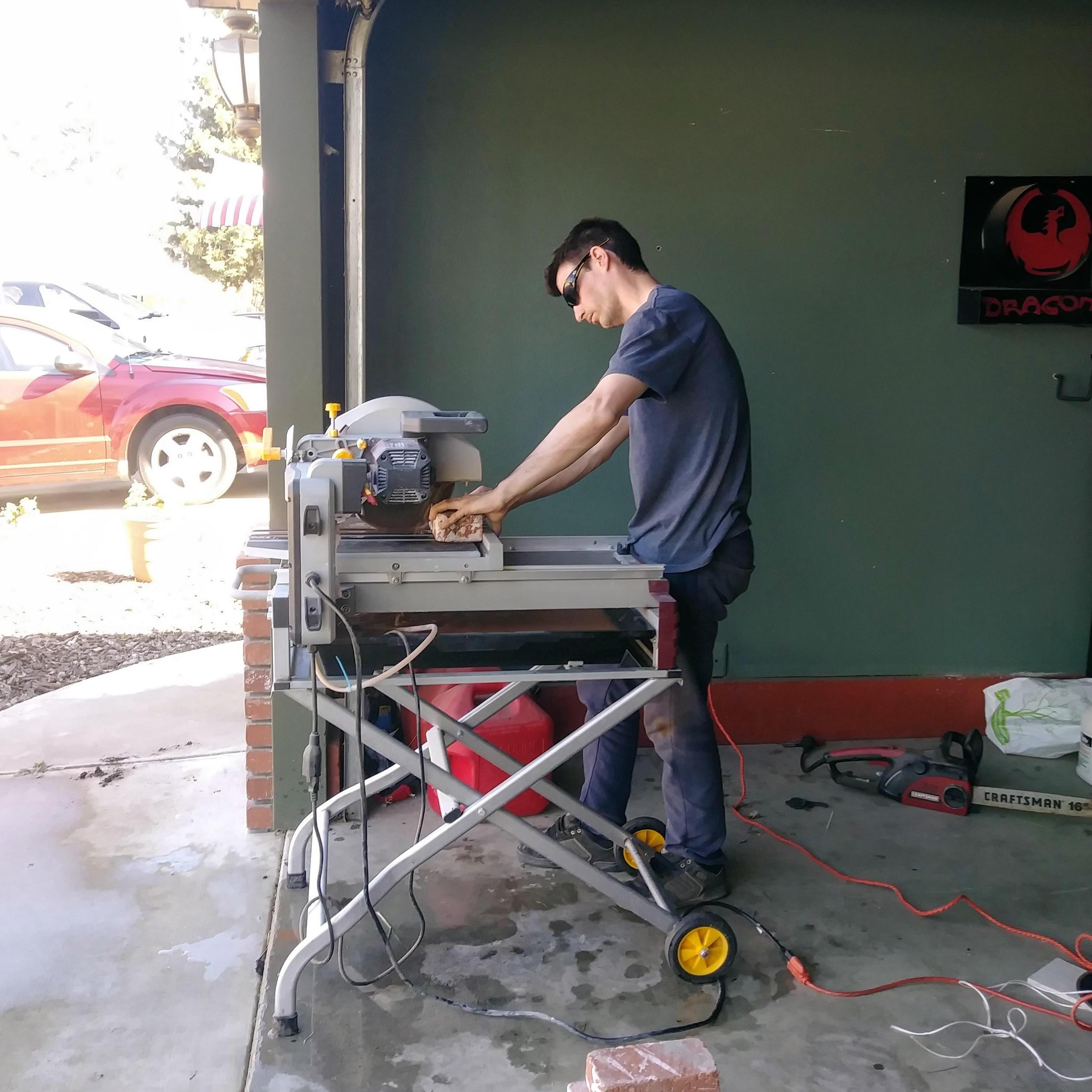 Arron cutting bricks for the yard