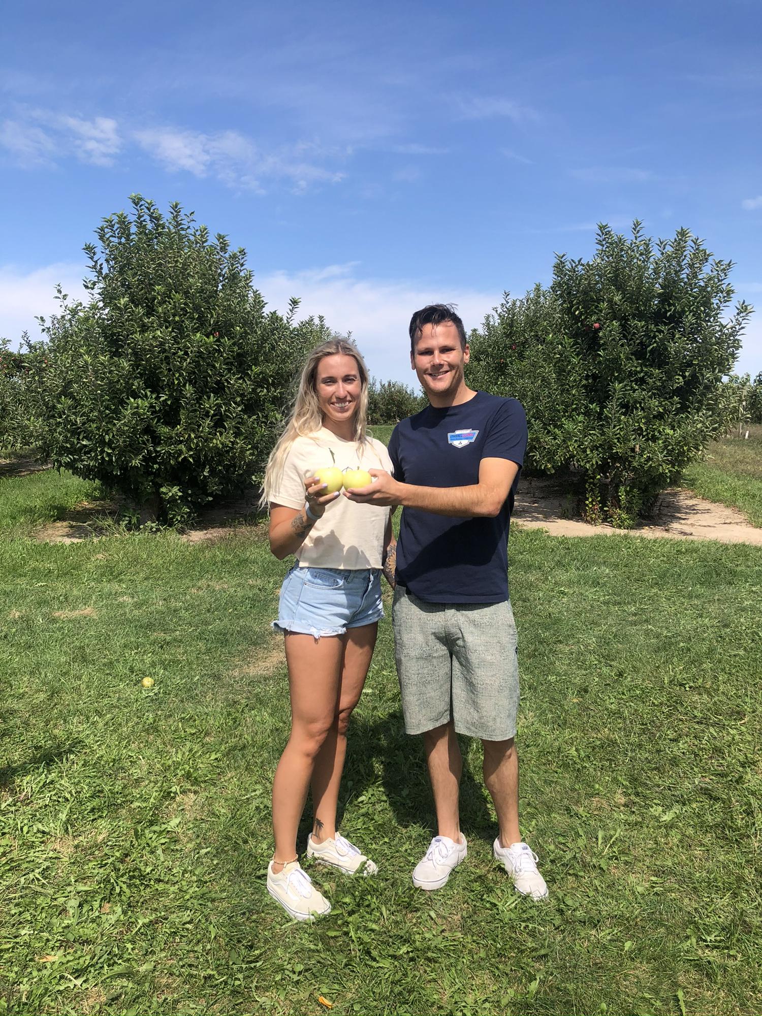 Apple picking featuring squinty eyes.