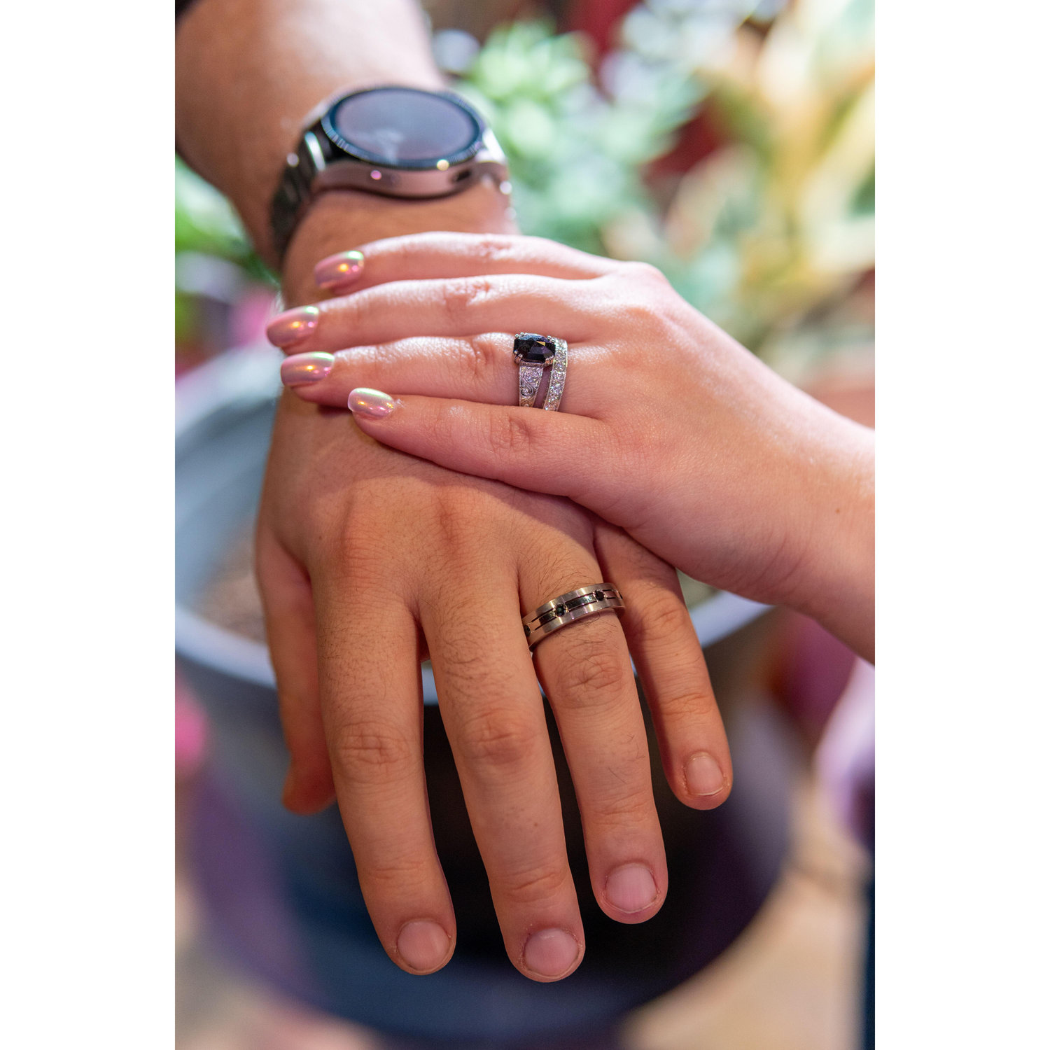 Our rings, custom made. Isaac's ring has black diamonds to compliment Emily's engagement ring. Emily's ring is an eternity band comprised of diamonds worn by her great-grandmother.