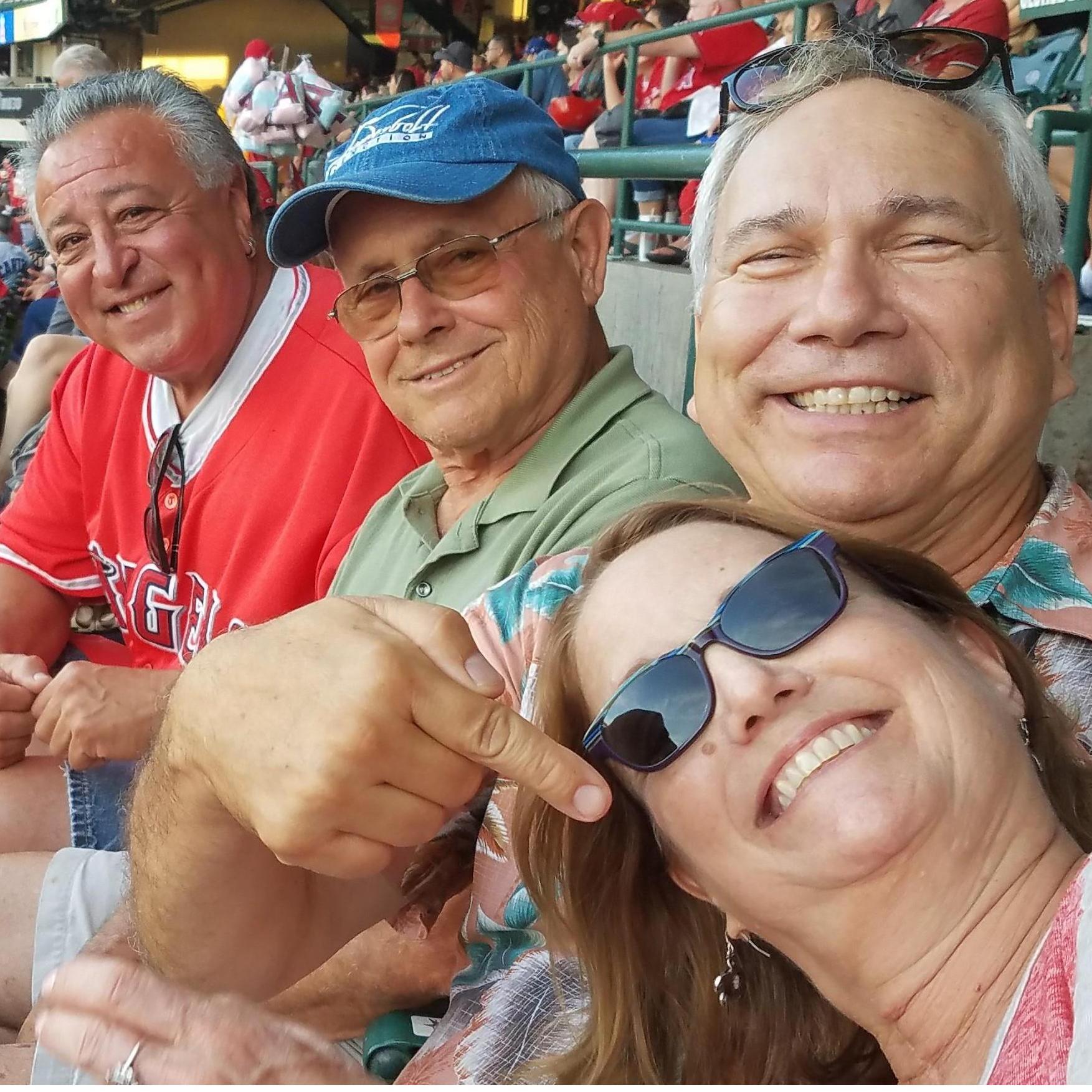 George's childhood friend, Fred Luera (left) and business partner Steve Warshauer with George & Hope at an Angel game.