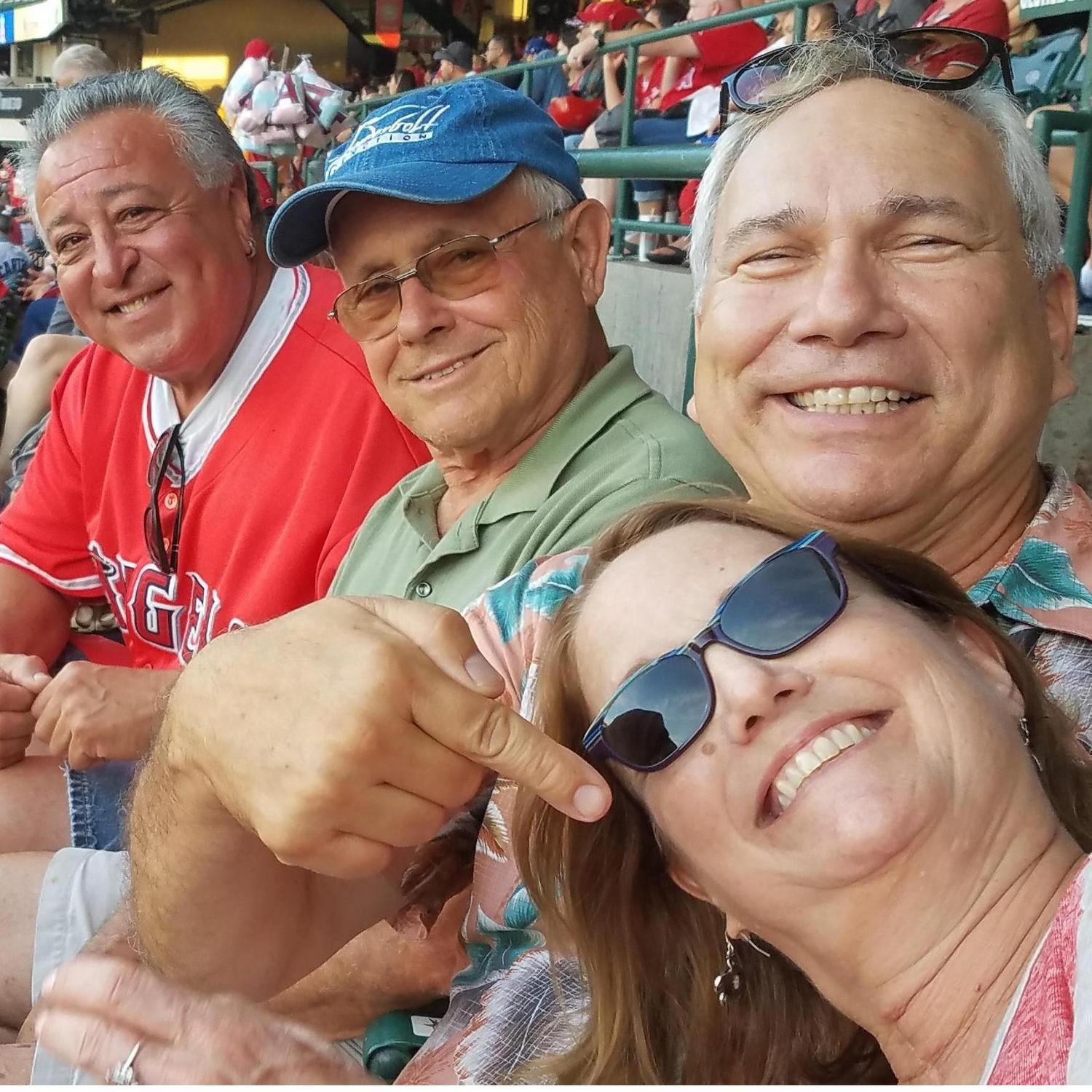 George's childhood friend, Fred Luera (left) and business partner Steve Warshauer with George & Hope at an Angel game.