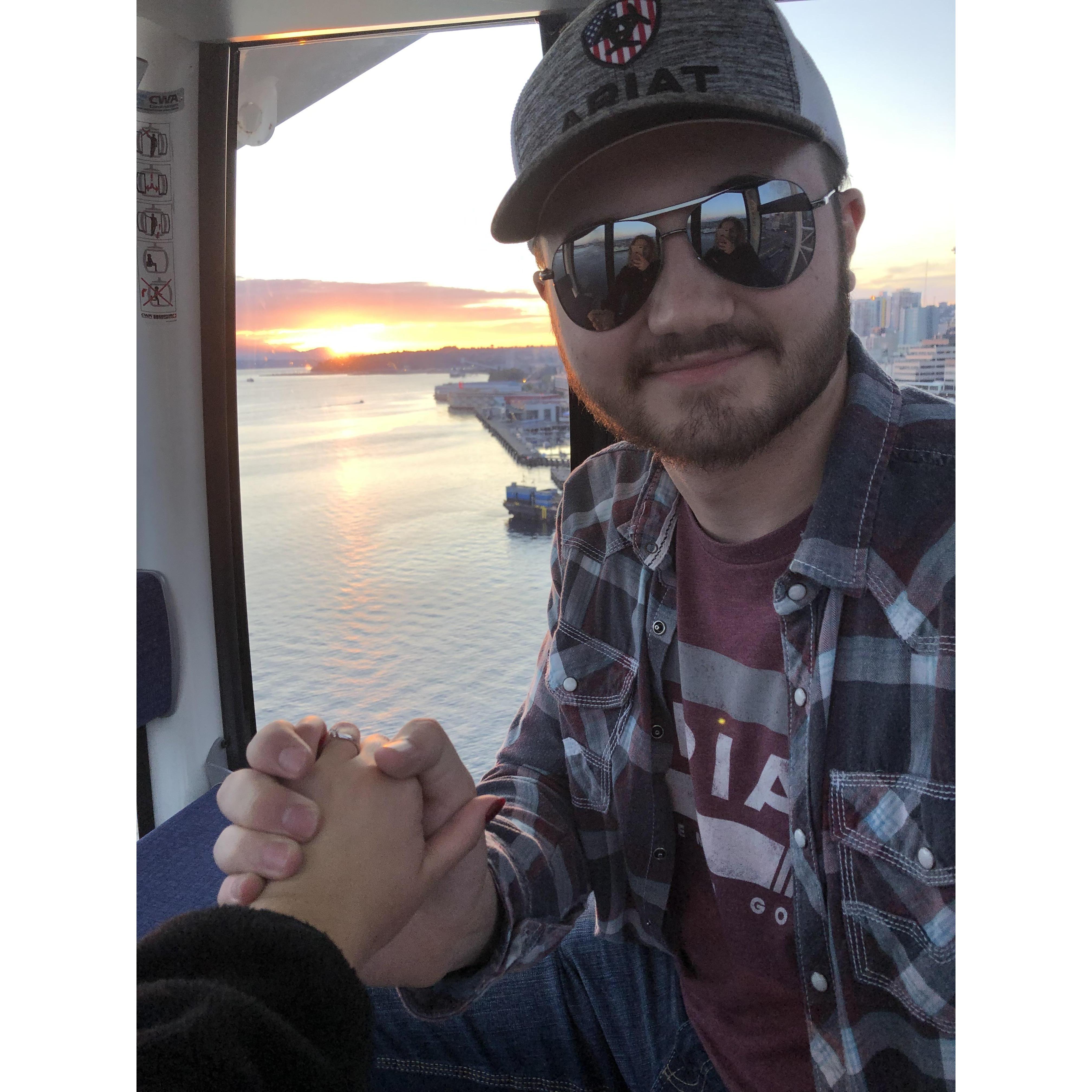 The proposal. The top of the ferris wheel at sunset in Seattle.