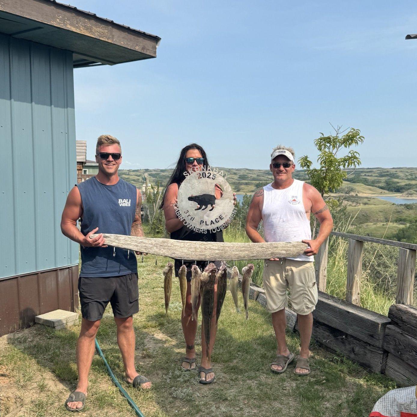 Gereth, Sharlee, and Dad with their trophy from the Cabin Owner's Tournament