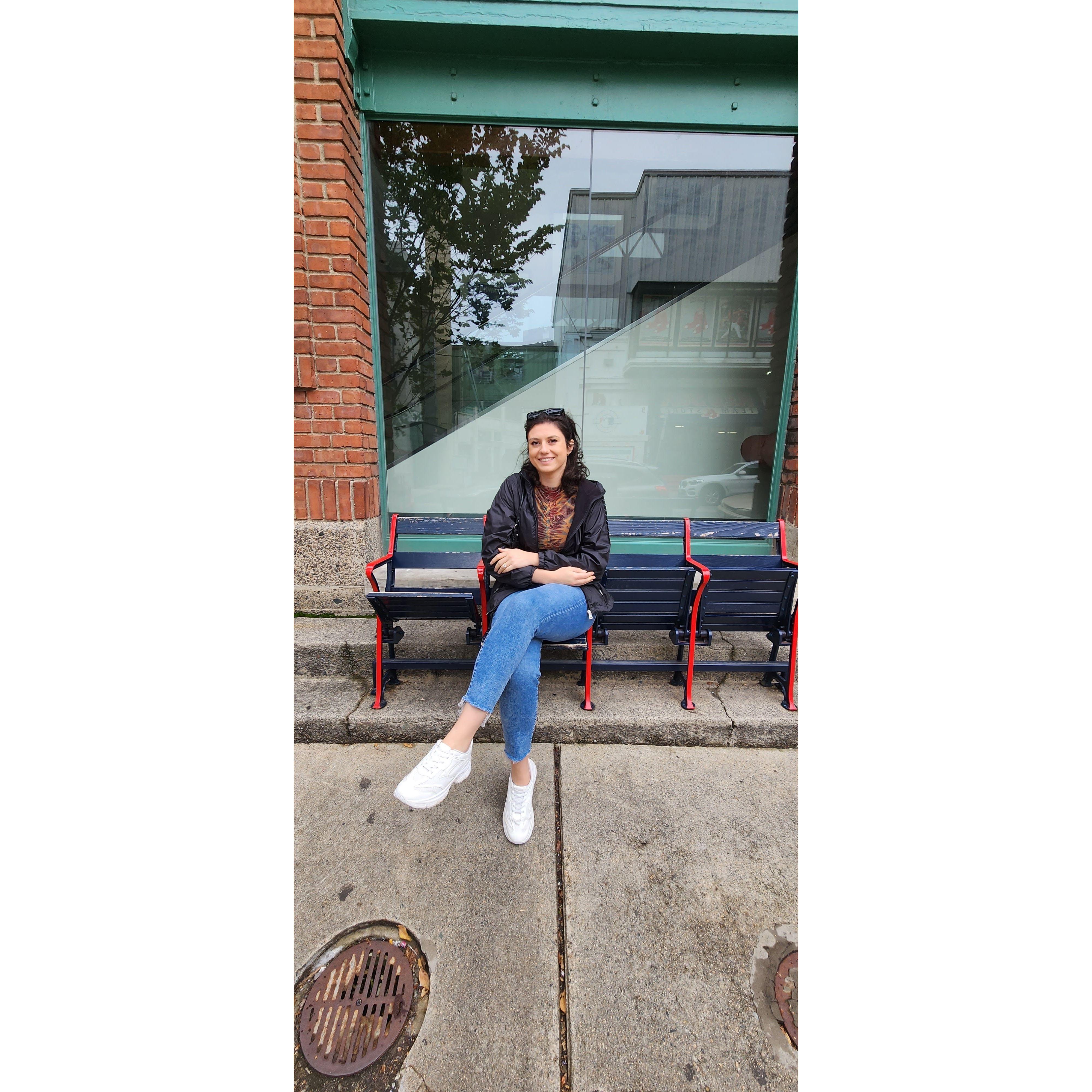 Elizabeth resting her feet outside of Fenway Park after walking the entire city of Boston