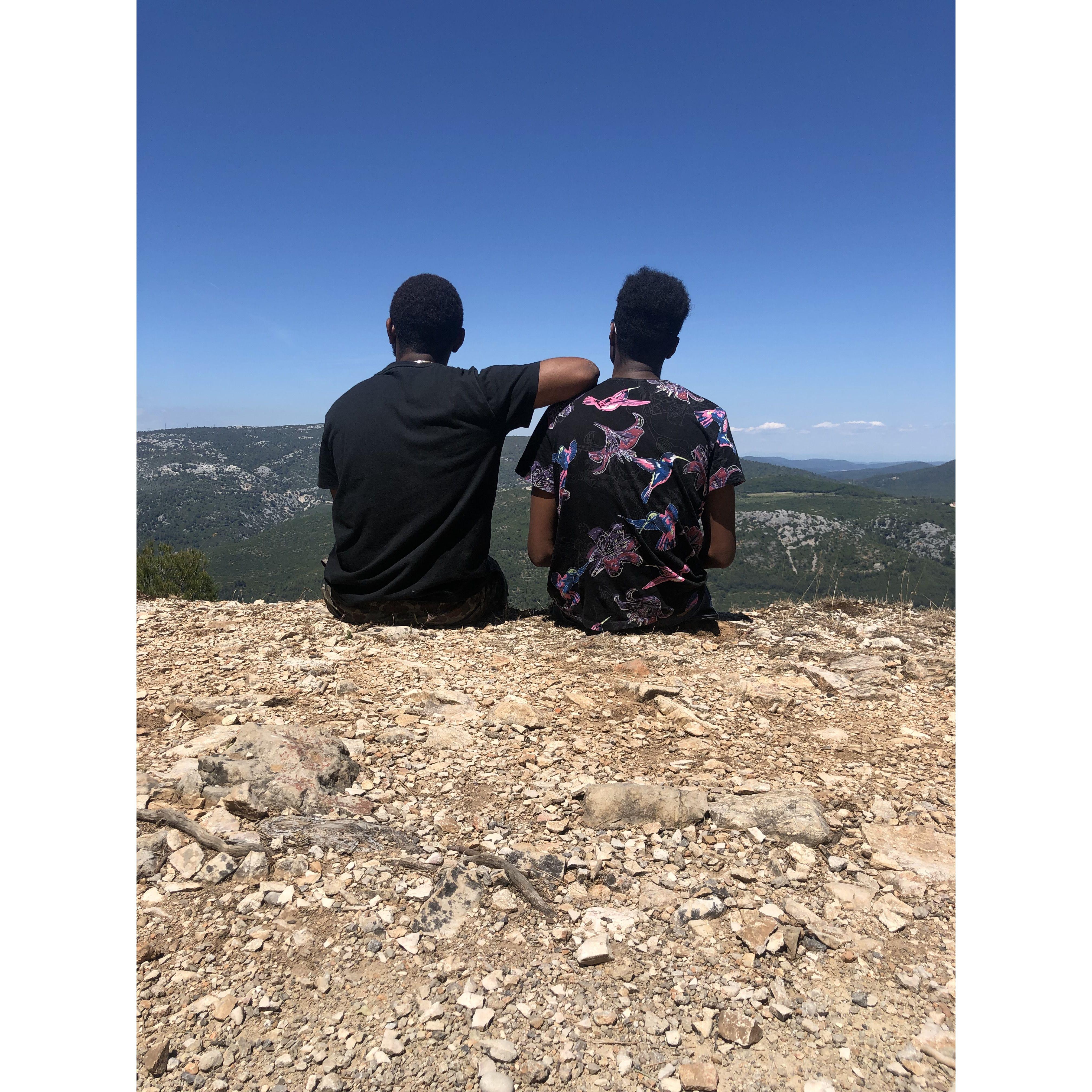 Robert and Kor sitting on the edge of a cliff in France!