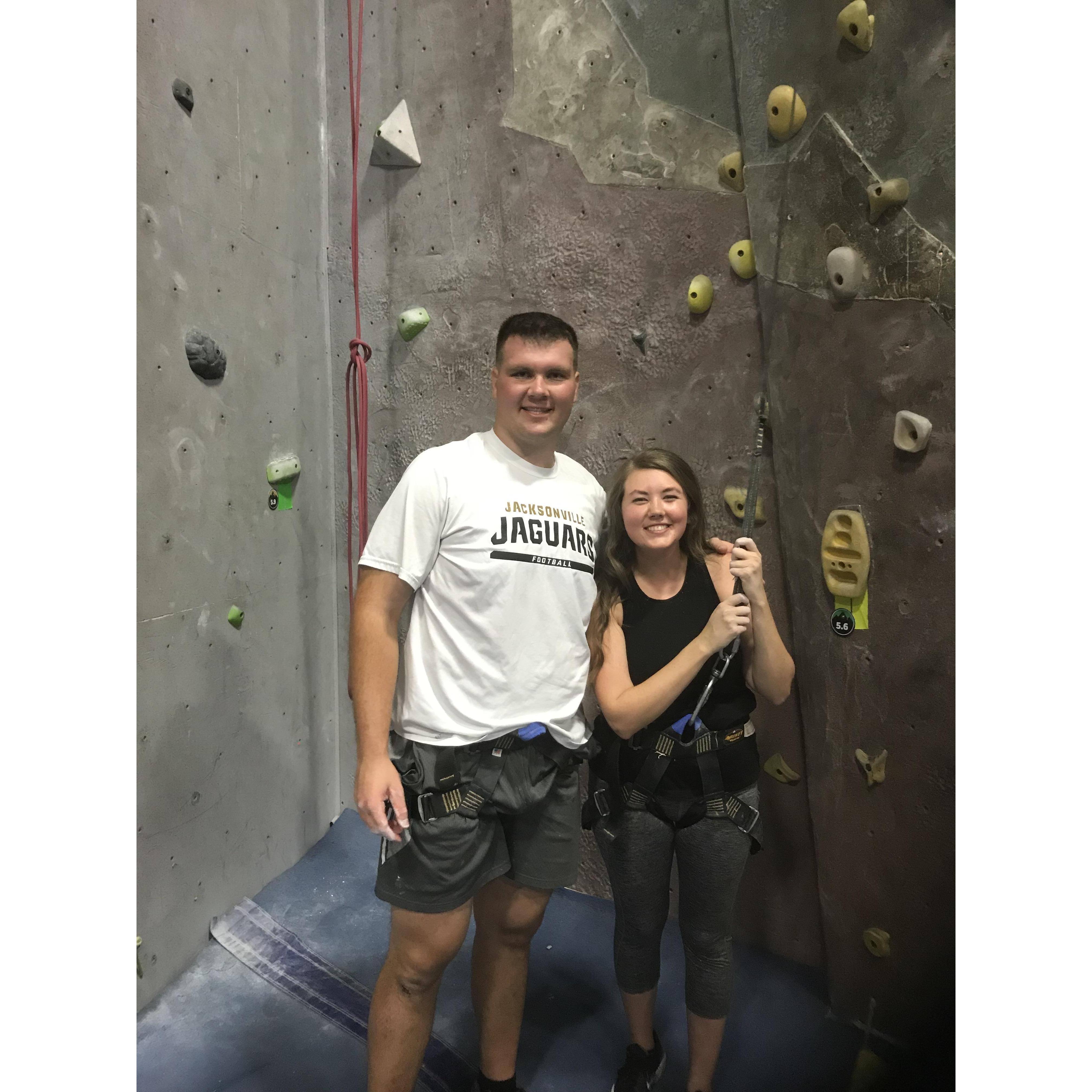 Our first photo together! Rock climbing with our friend and now bridesmaid Delanie who set us up together.
