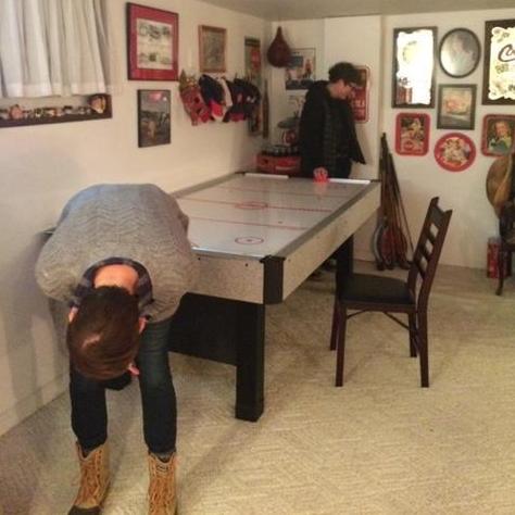Just before we were together - the moment Tricia beat Jennifer at air hockey. Tricia is bent over in joy; Jennifer is turning away in shame. This was the start of a pattern of bar game lashings.