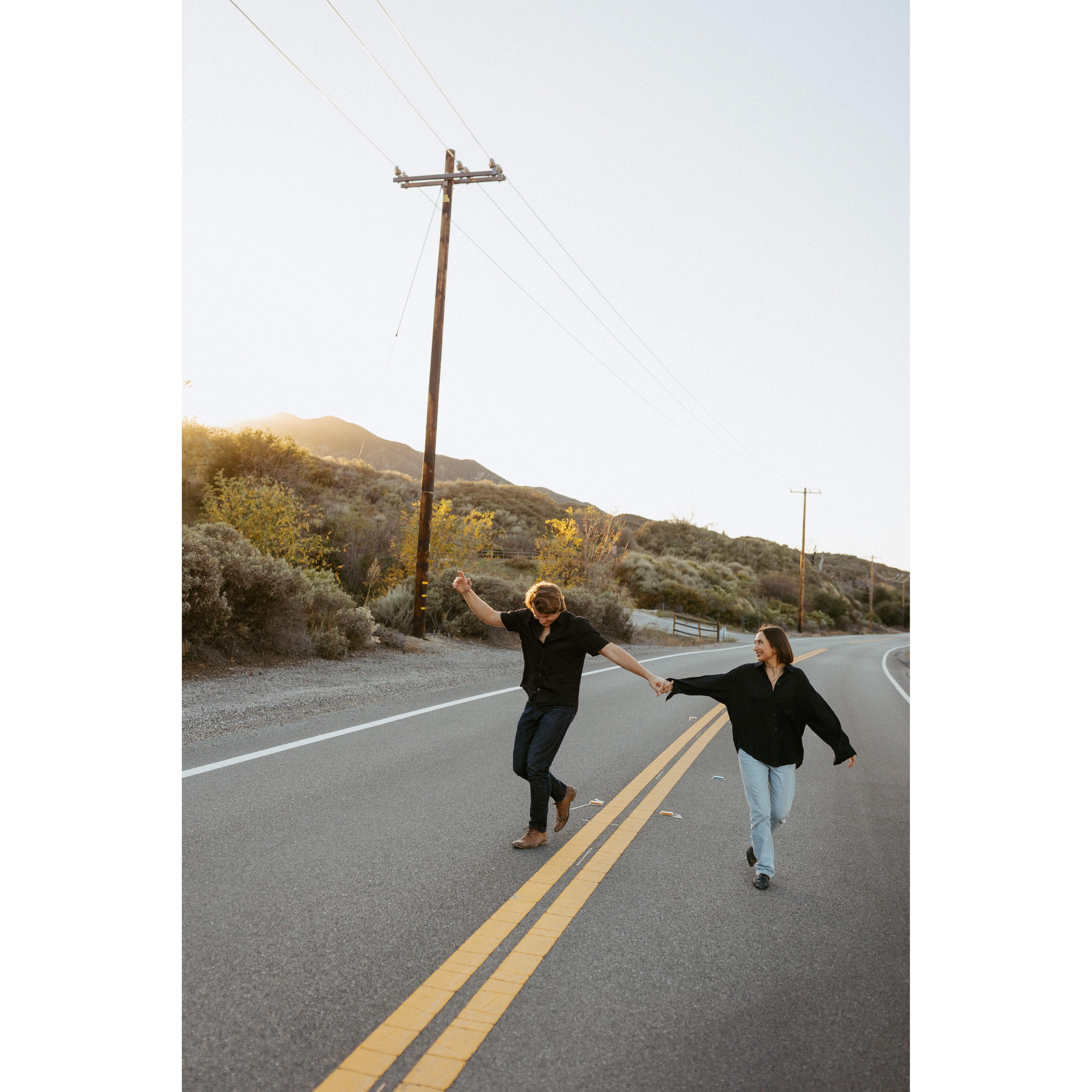 Victoria & Leo dancing in the streets at their engagement photoshoot.