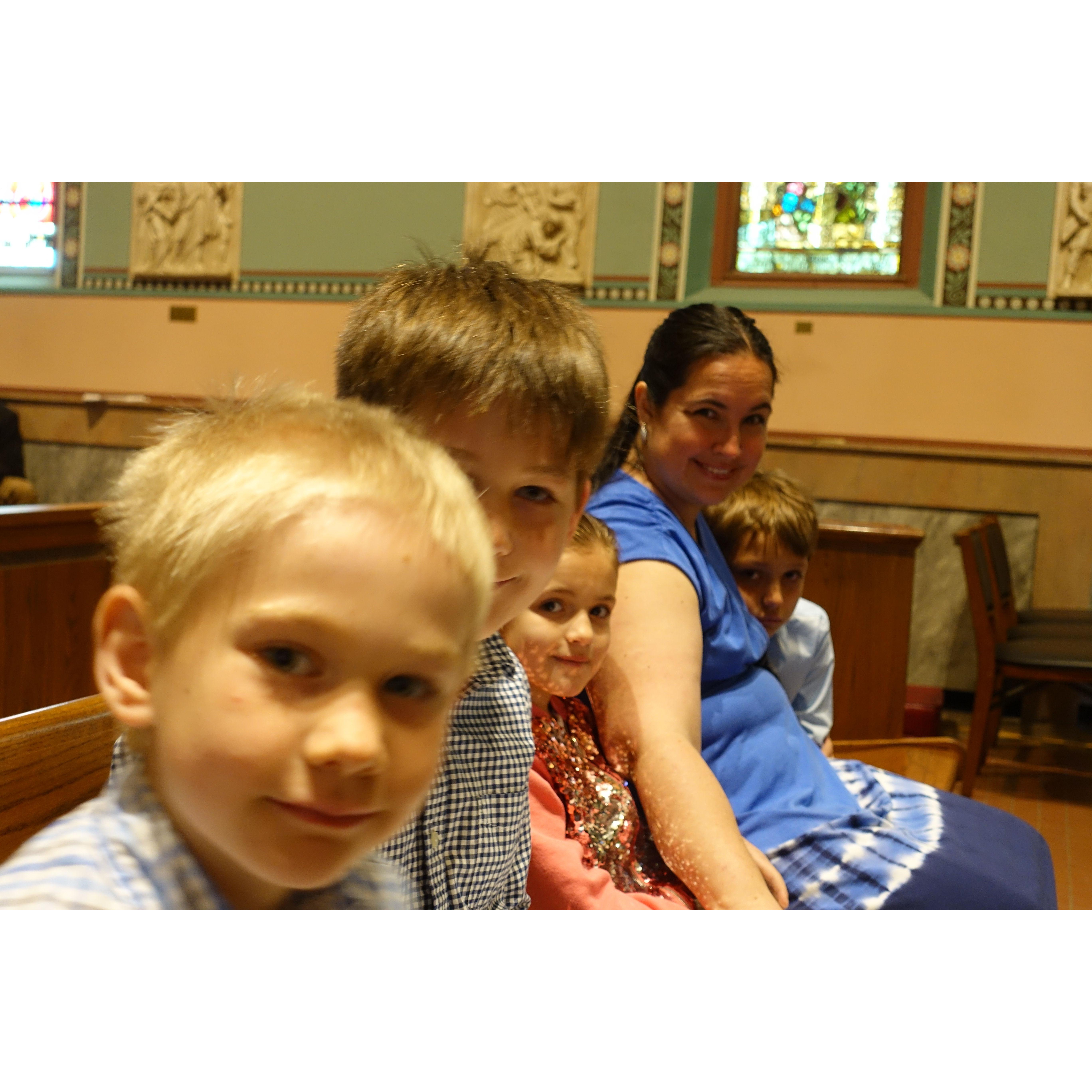 Agnes is first communion while we all watch.