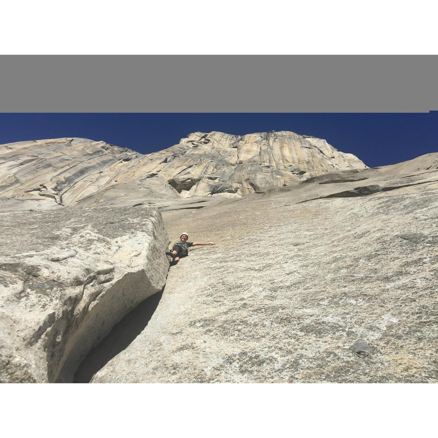 Climbing on El Capitan. There's a rope, it is just hard to see in the photo.