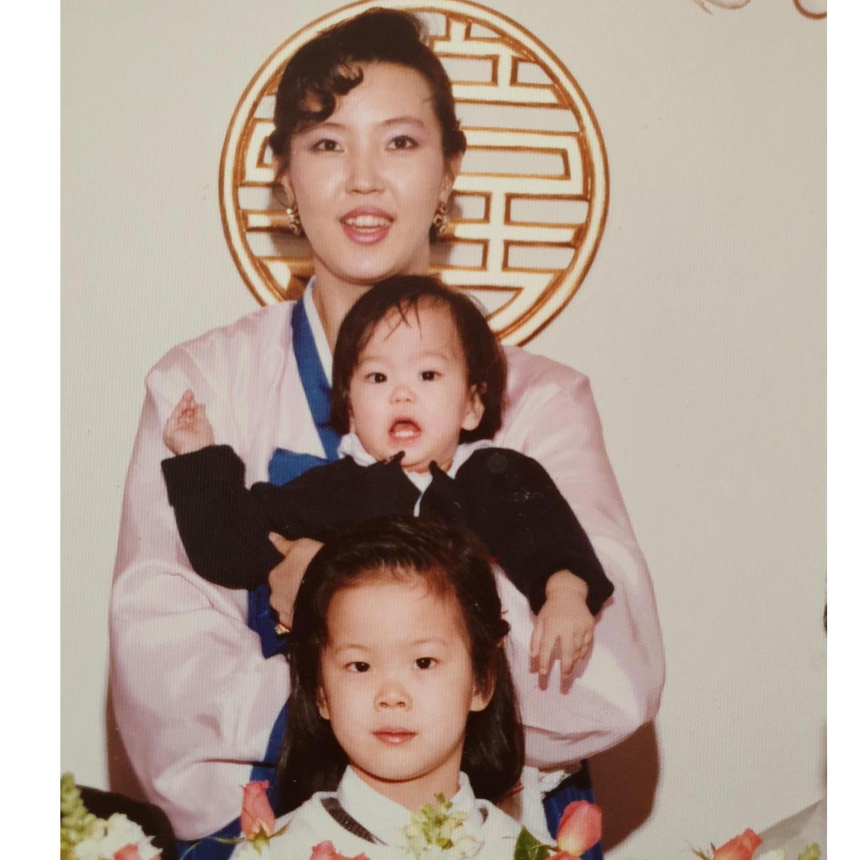 Mom holding my sister, then me!