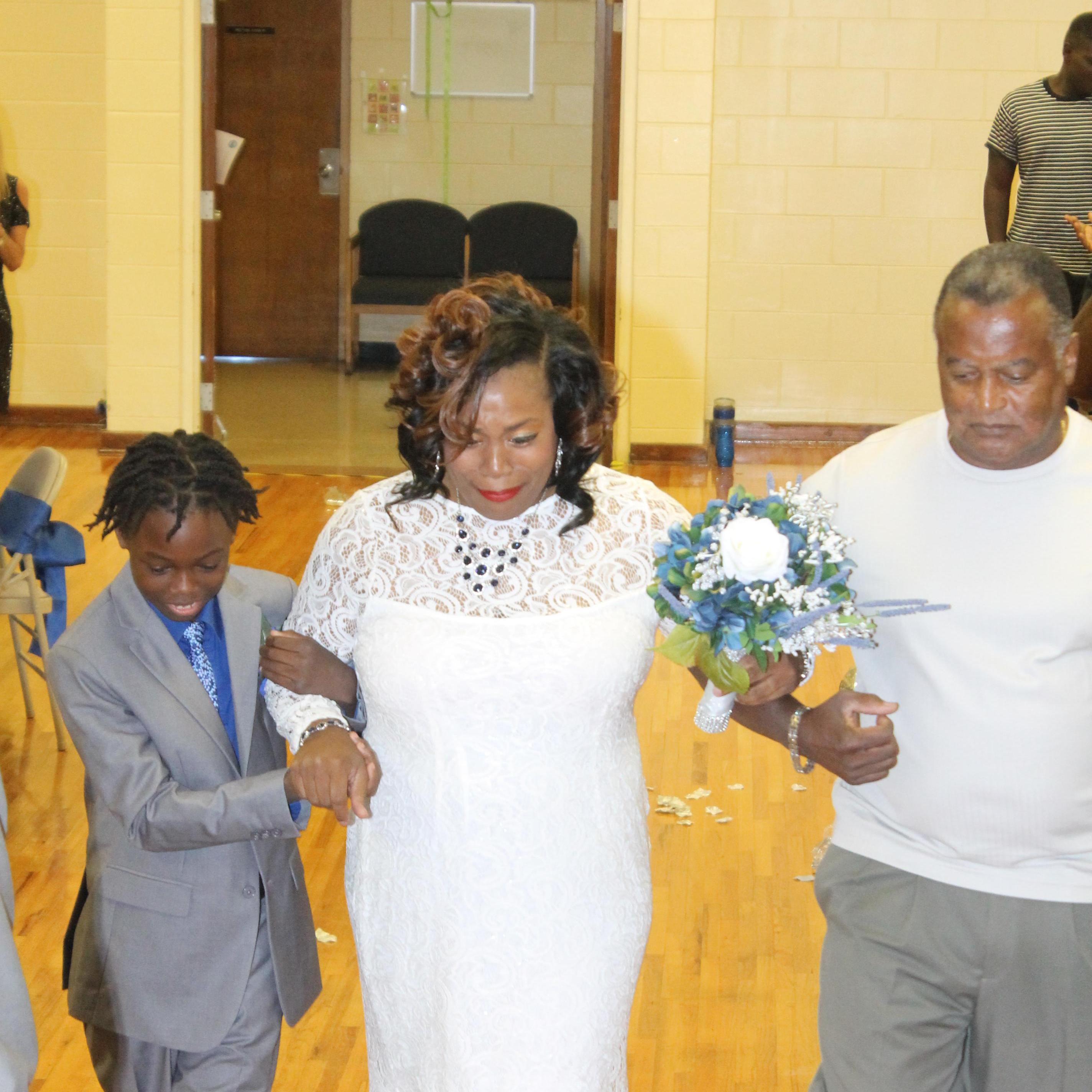 Emotional moment when a daughter is walked down the aisle with her father and son. When arrived to the end of the aisle but the beginning of a new chapter.