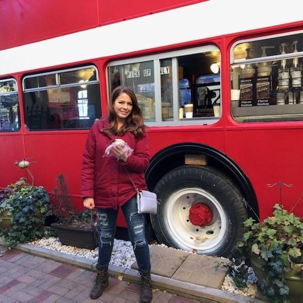 Emily enjoying a delicious muffin from the double decker coffee bus in Downtown Asheville.