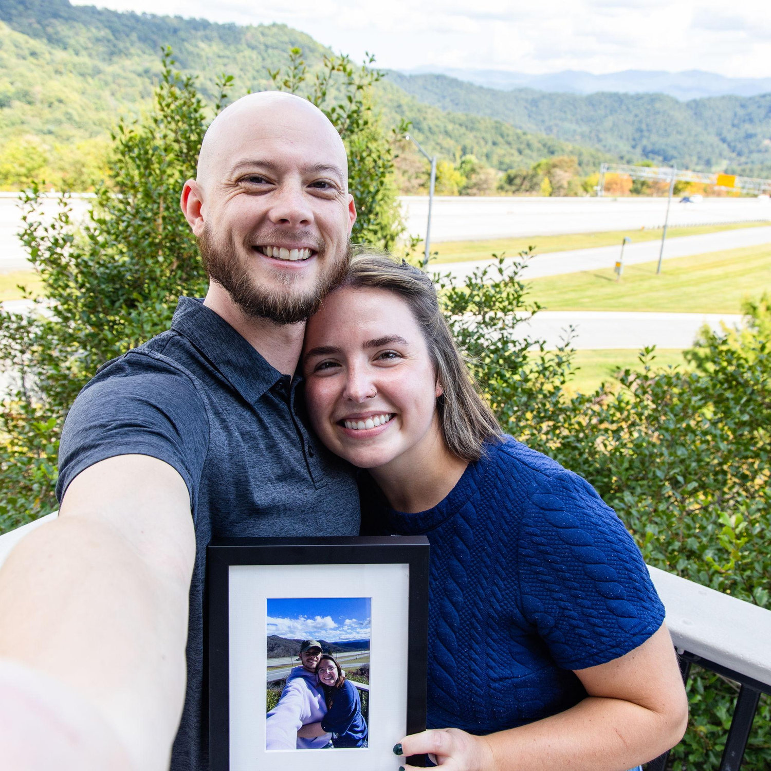 Engagement in 2025, with us holding our photo at this spot from 2022