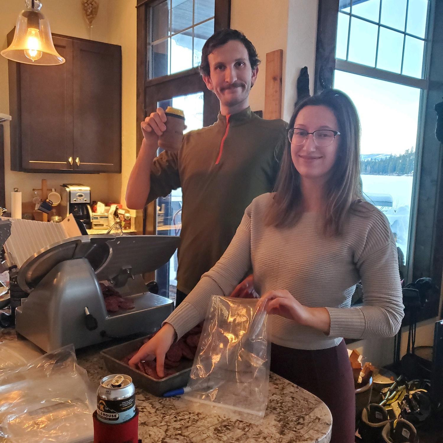 Cutting home made elk salami. Yum! February 2022