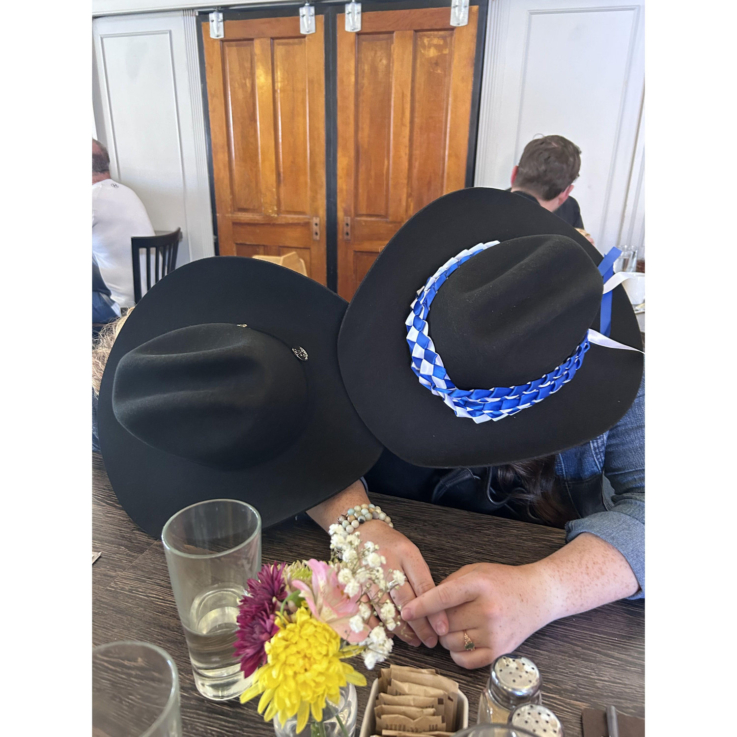 Ainsley and Brian using their Stetsons to their advantage at a post-graduation brunch with their families