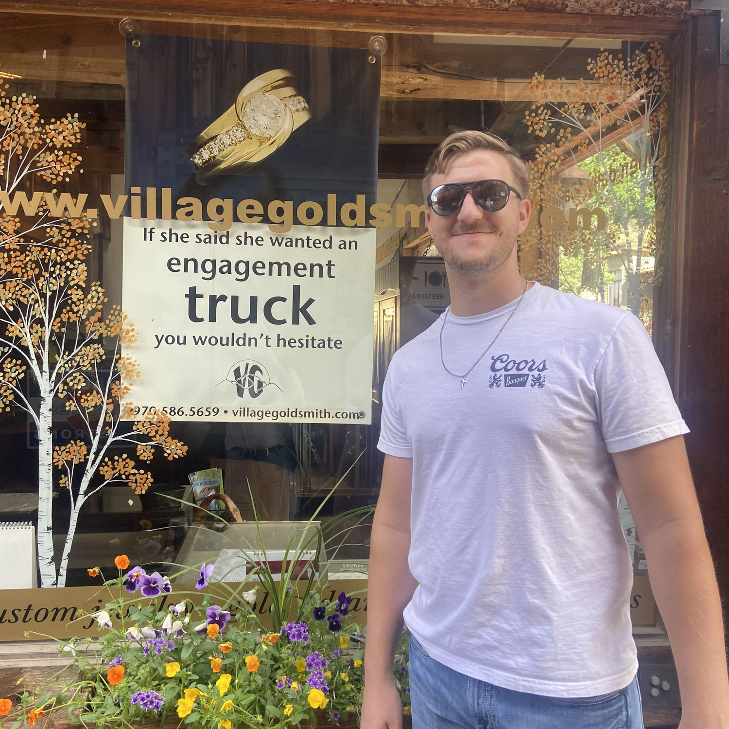 Laura made Jesse-Wayne take a picture with this sign 1 day before he proposed. She had no idea it was coming because he had just bought a truck.