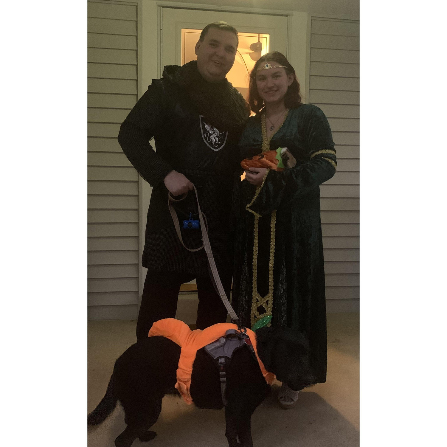 Our family photo on Halloween, 2023. It includes both of us, Storm the black lab and Cobalt the guinea pig.