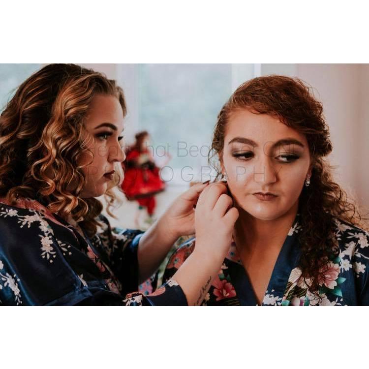 Rebekah Jones helping the Bride finish getting ready 
Photo credit to: A Heart That Beats For One Photography