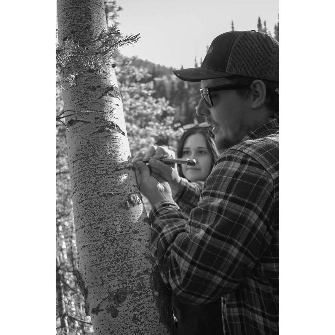 Pey carving P&K into tree. Snapped by Jozlyn K Photography