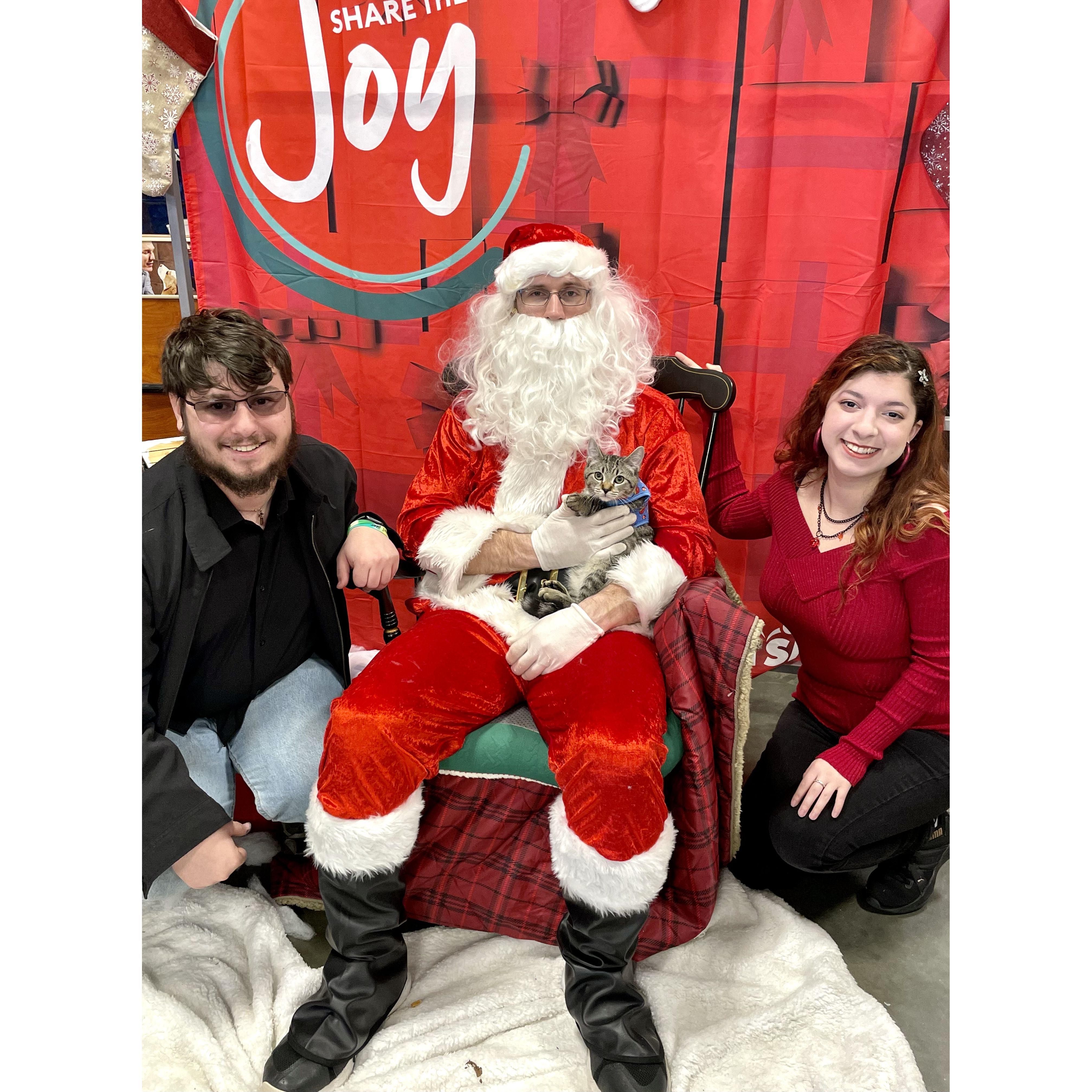Our first Christmas with our cat Aztec! Photo was taken at the Petsmart where we adopted him from. Family photo Dec '22