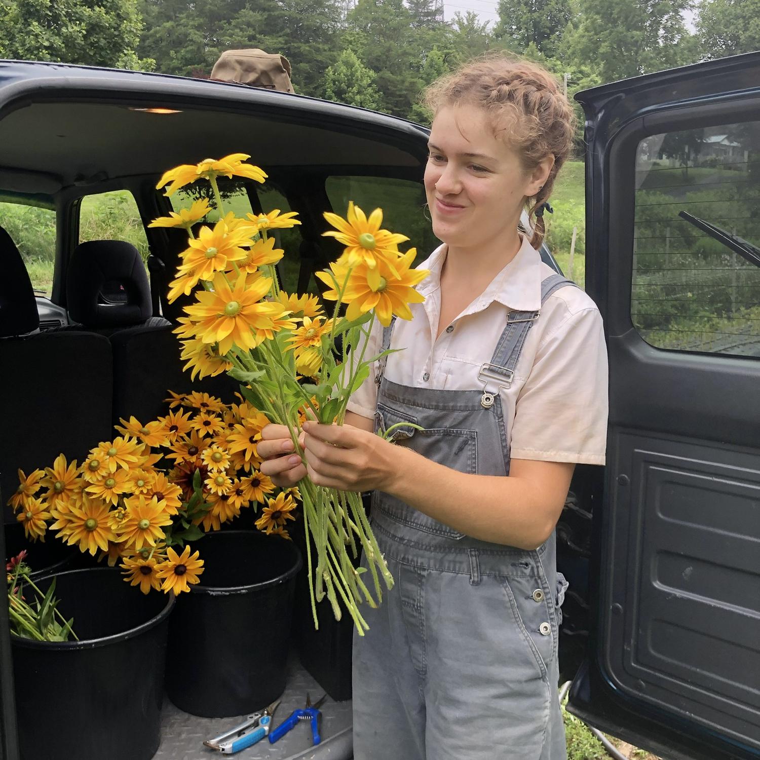Lucy helping harvest flowers when Morgan worked on a Flower Farm