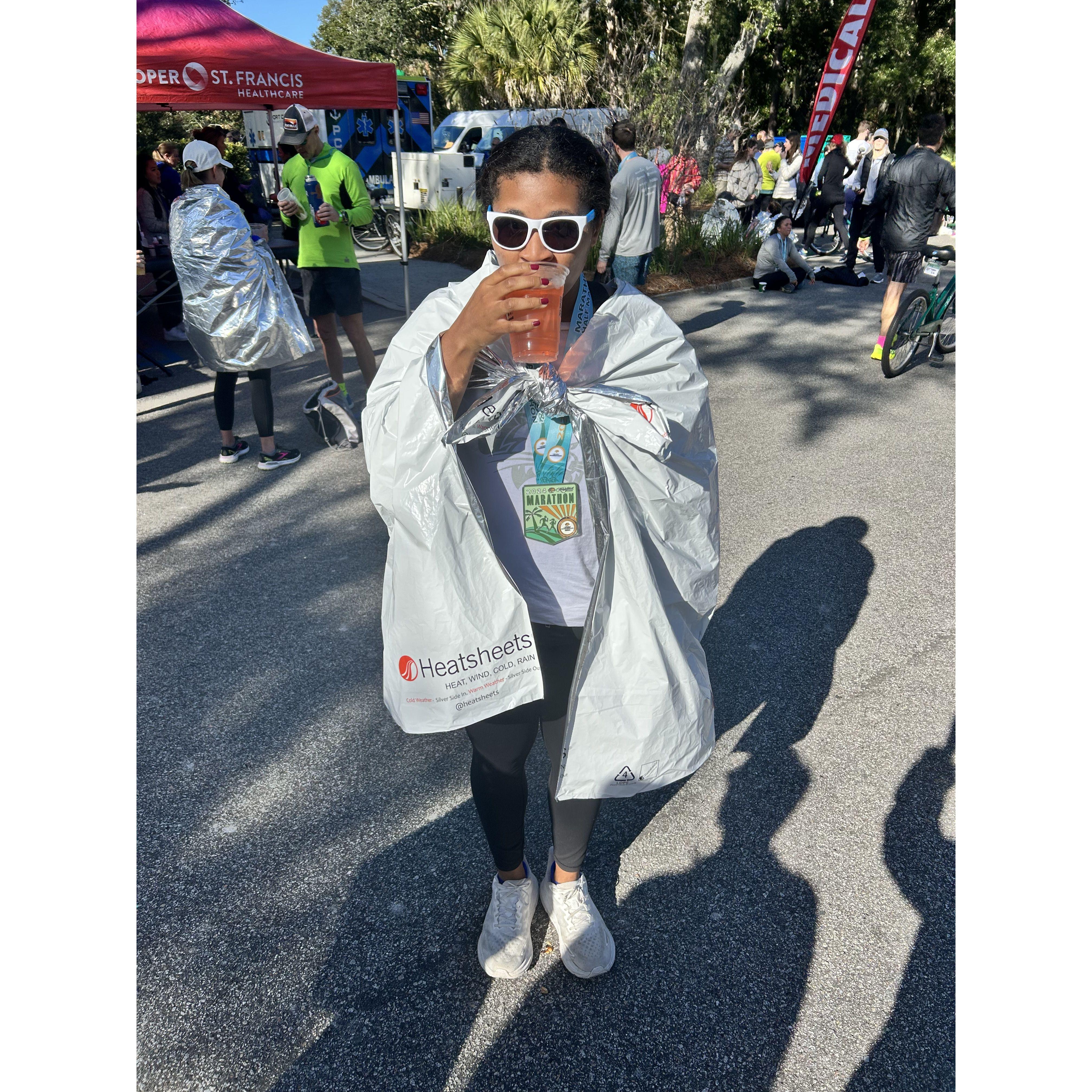 Liz after her first half marathon with a Truly as a recovery drink December 2024