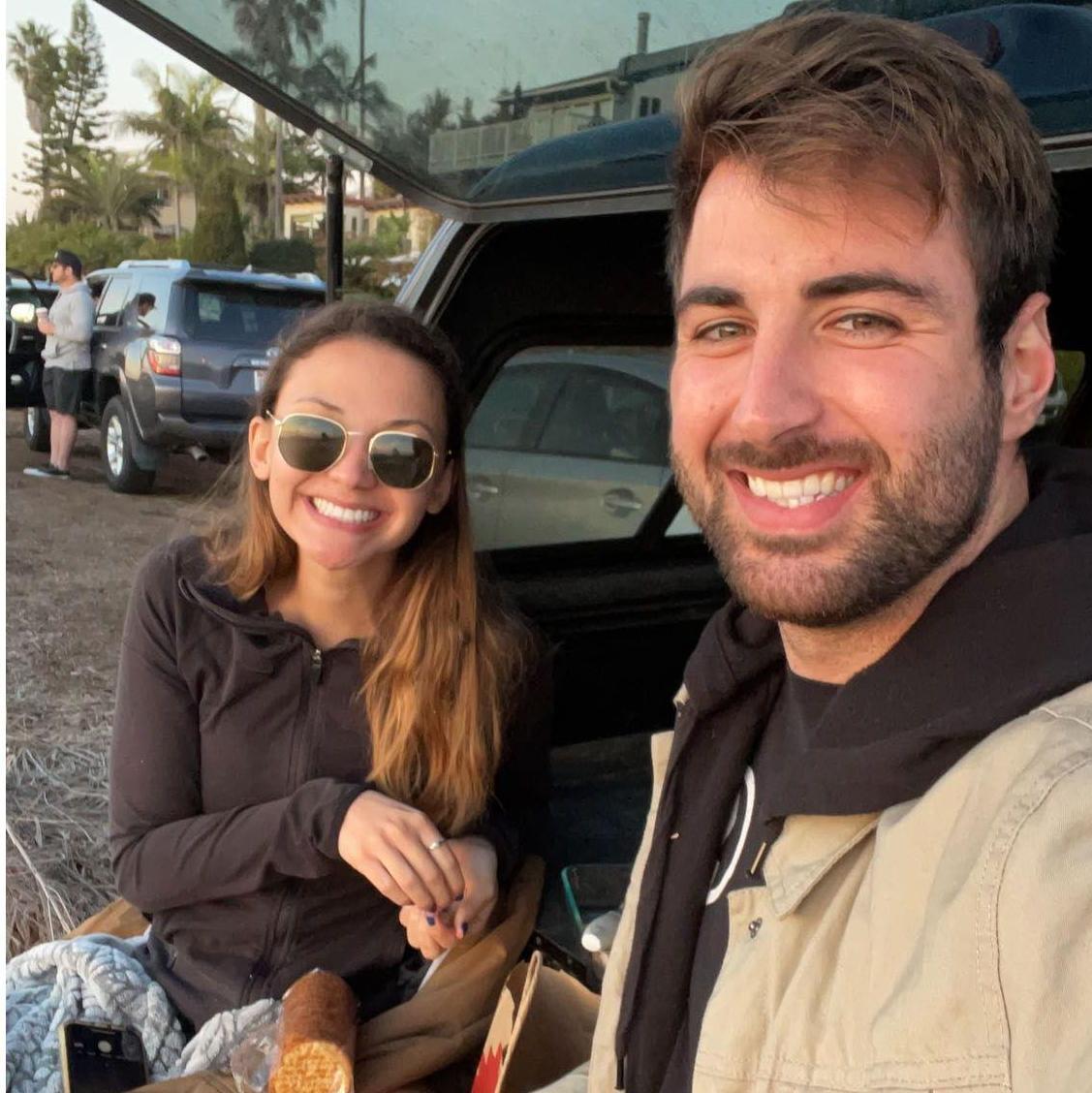 One of our first photos together (2020) doing one of our favorite activities: snacks & sunset at the beach