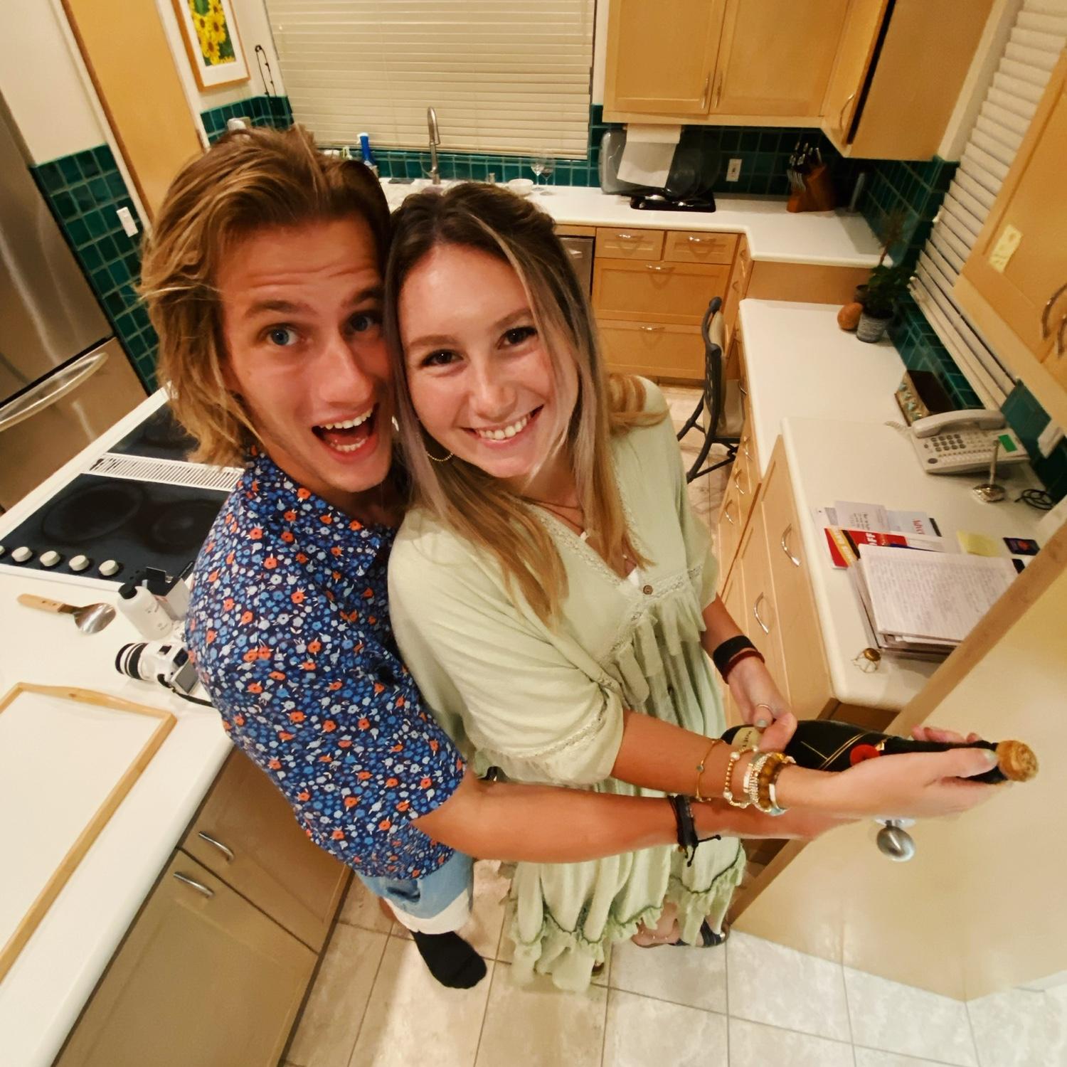 Popping our first champagne cork as an engaged couple - 07.16.22