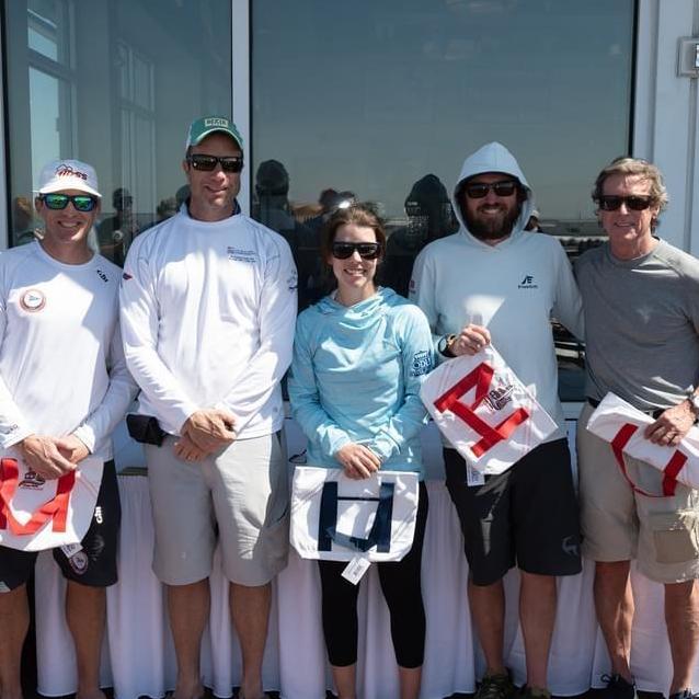 Sarah with the Doll Baby crew accepting first place at the 2020 J22 Midwinters Championship at SYC.