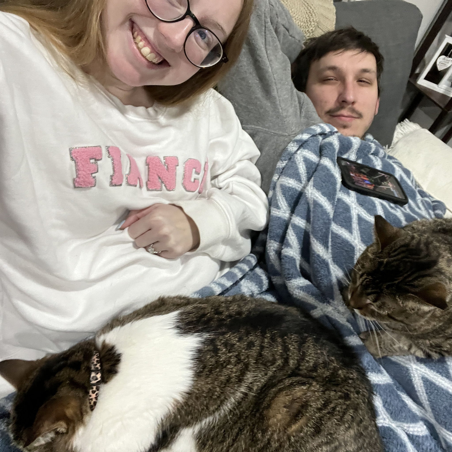 The whole fam all cuddled on the couch.