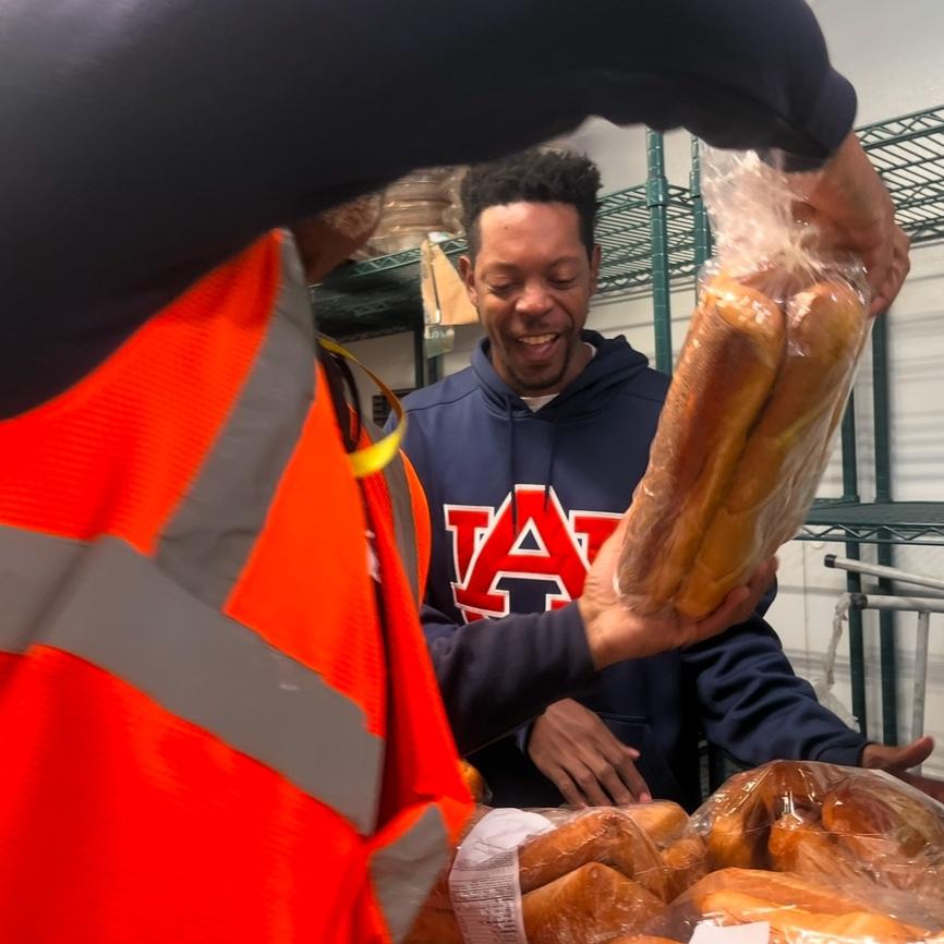 Volunteering-acts of service to the community at True Divine's monthly food drive