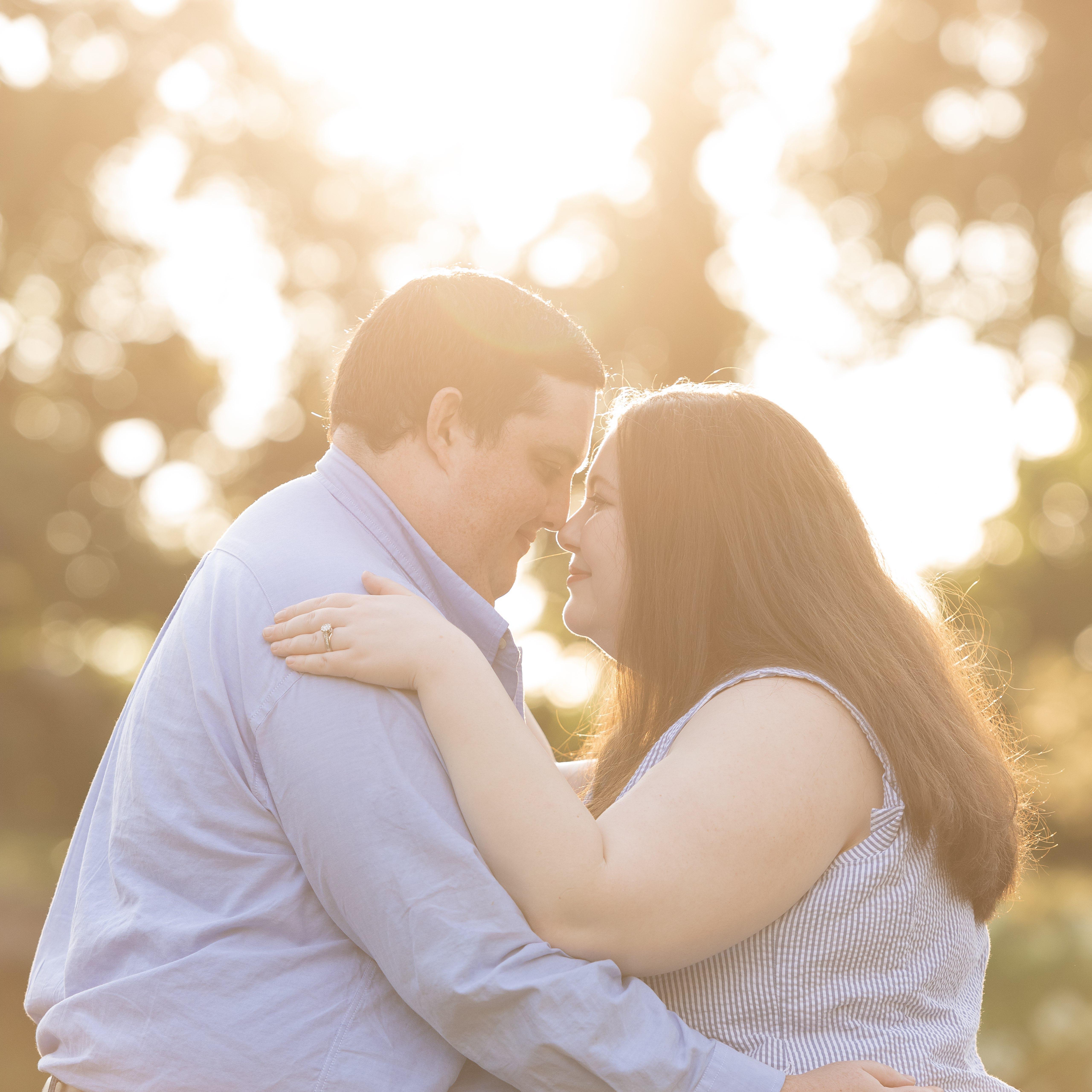 Marissa and Matt looking at and holding each other in front of trees