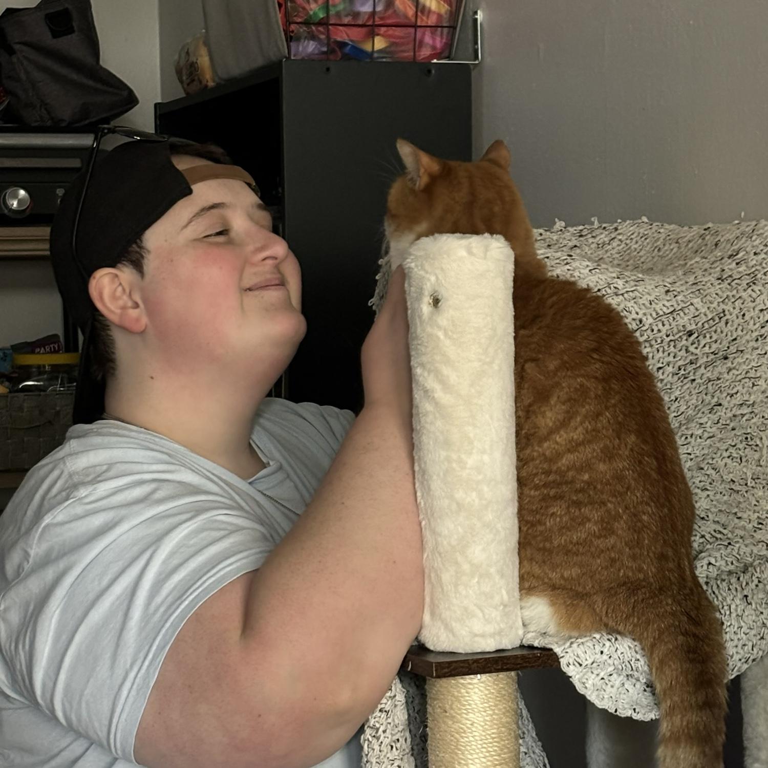 Here's Claire getting some chin scratches while on her cat tree!- Kelly
