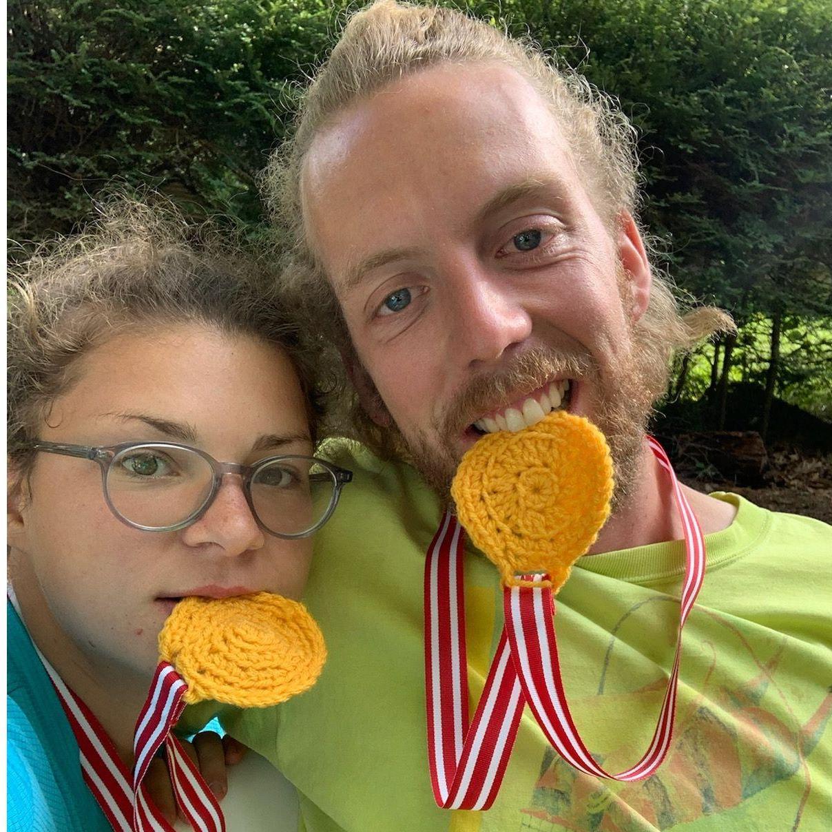 After our first triathlon. Shoutout to Memere for knitting our medals.