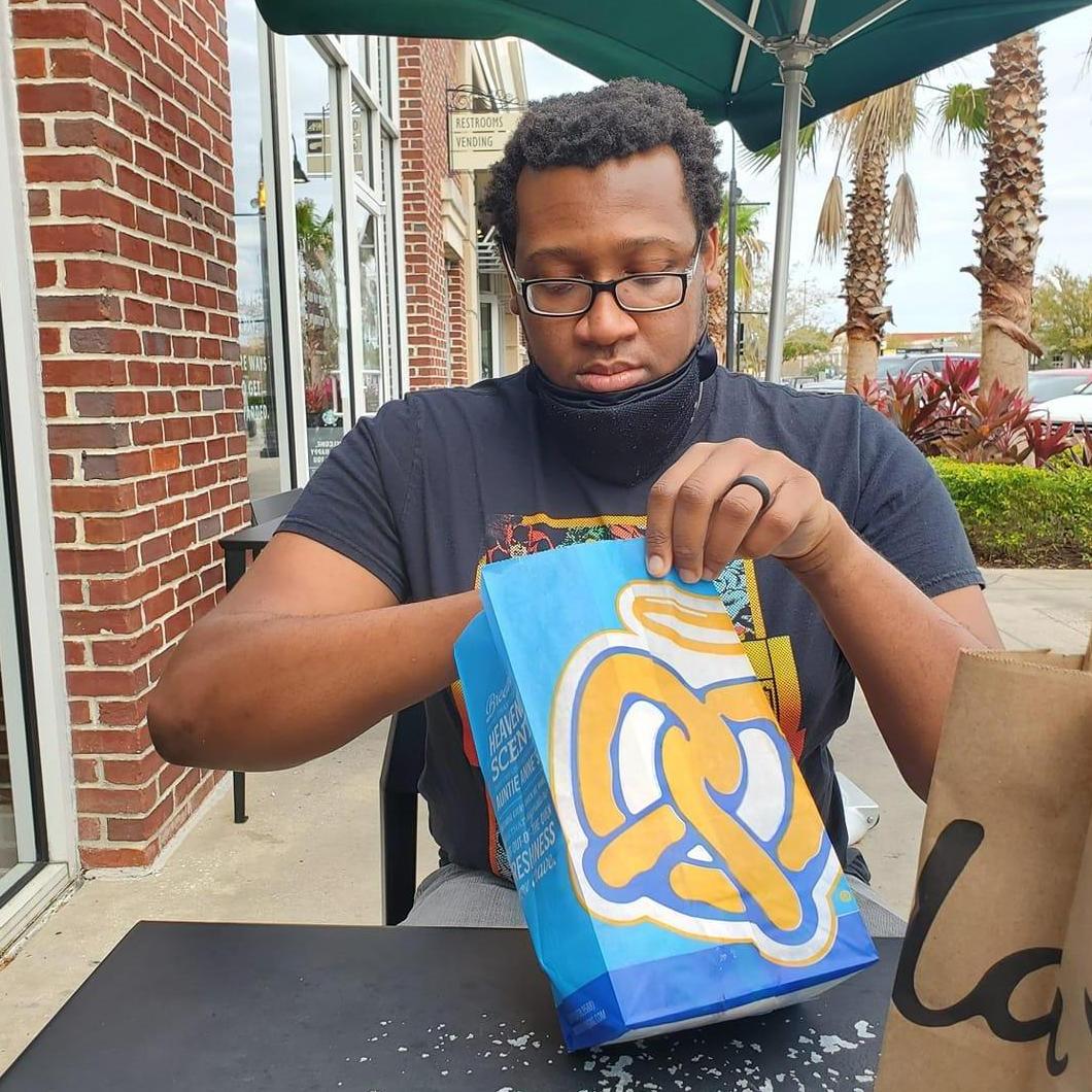 Randall enjoying a sweet and salty pretzel in Jacksonville at the St. John's Town Center.