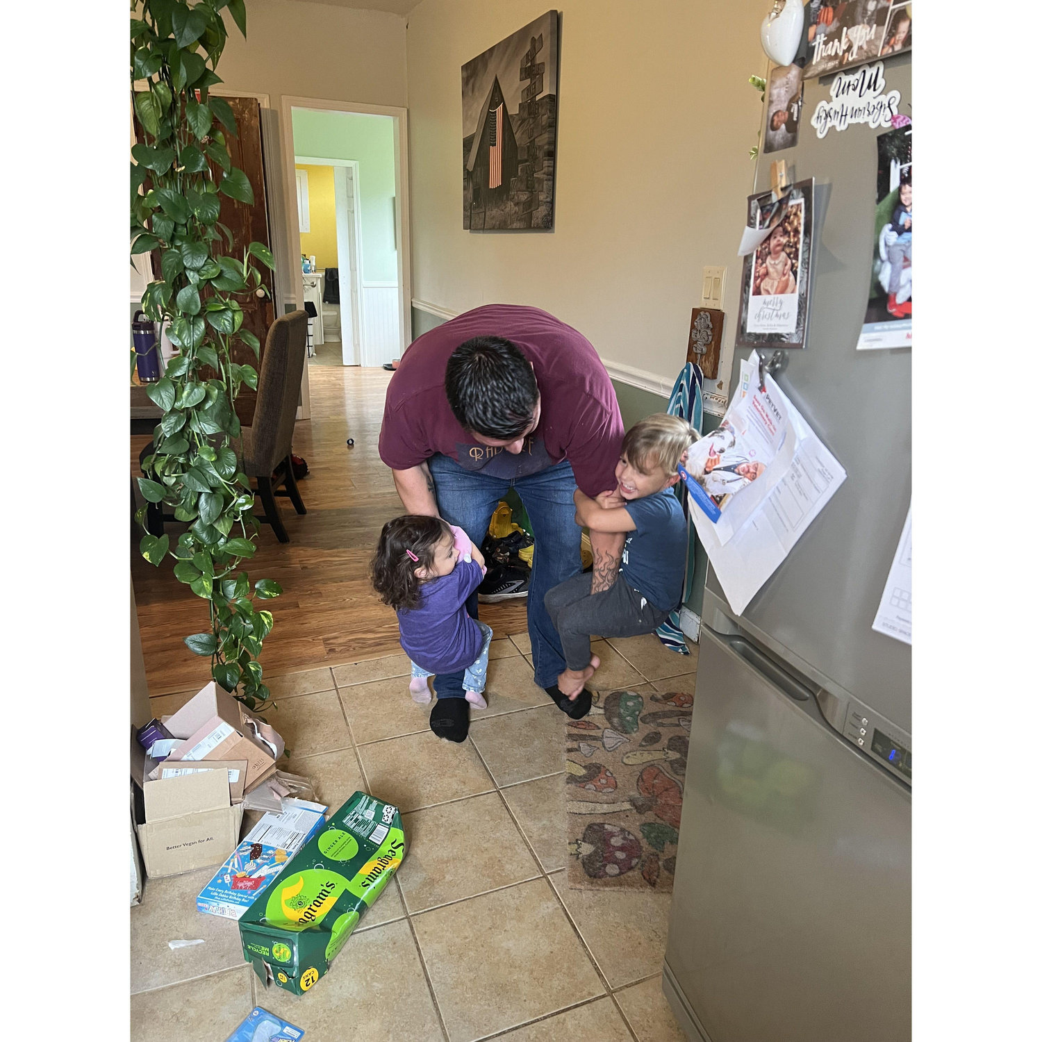 Penelope and Xavier using Chris as a jungle gym!