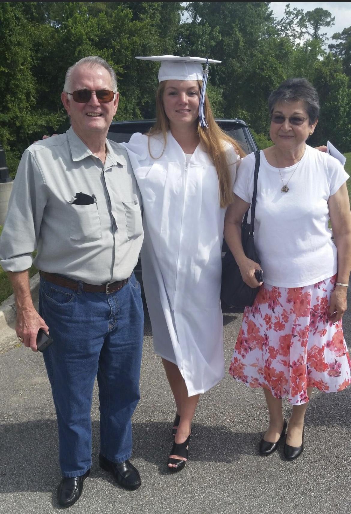 Lea with her grandparents at graduation
