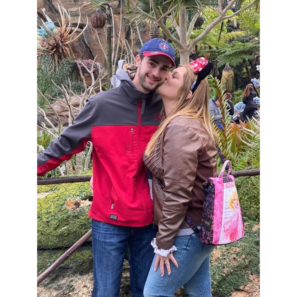 Sharing a kiss in Disneyland.